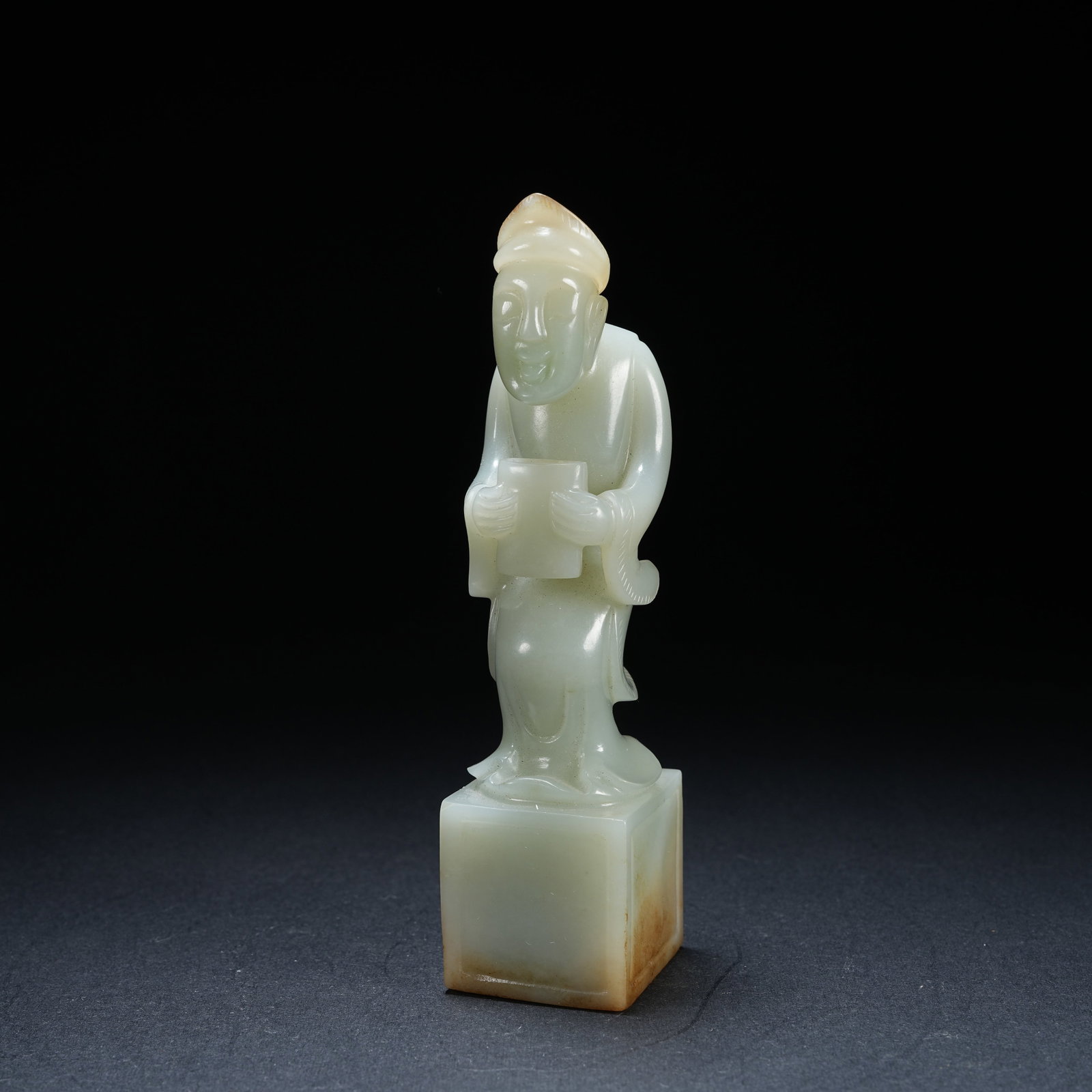 A HETIAN JADE SEAL WITH SQUATTING FIGURE KNOB: Hetian Jade Seal with Squatting Figure Knob