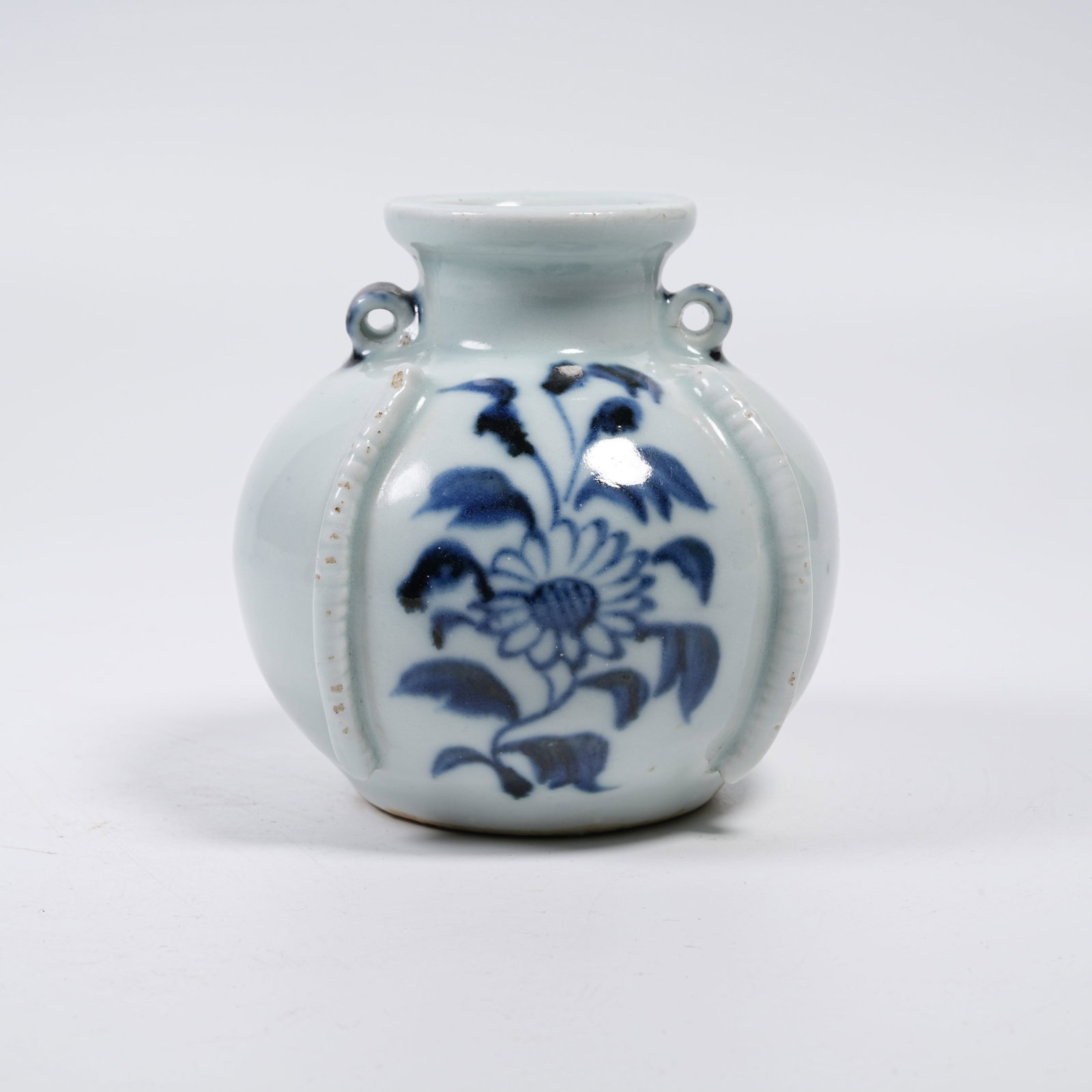 A SMALL BLUE AND WHITE TWO-LOOP JAR WITH FLORAL PATTERNS: Small Blue and White Two-loop Jar with Floral Patterns