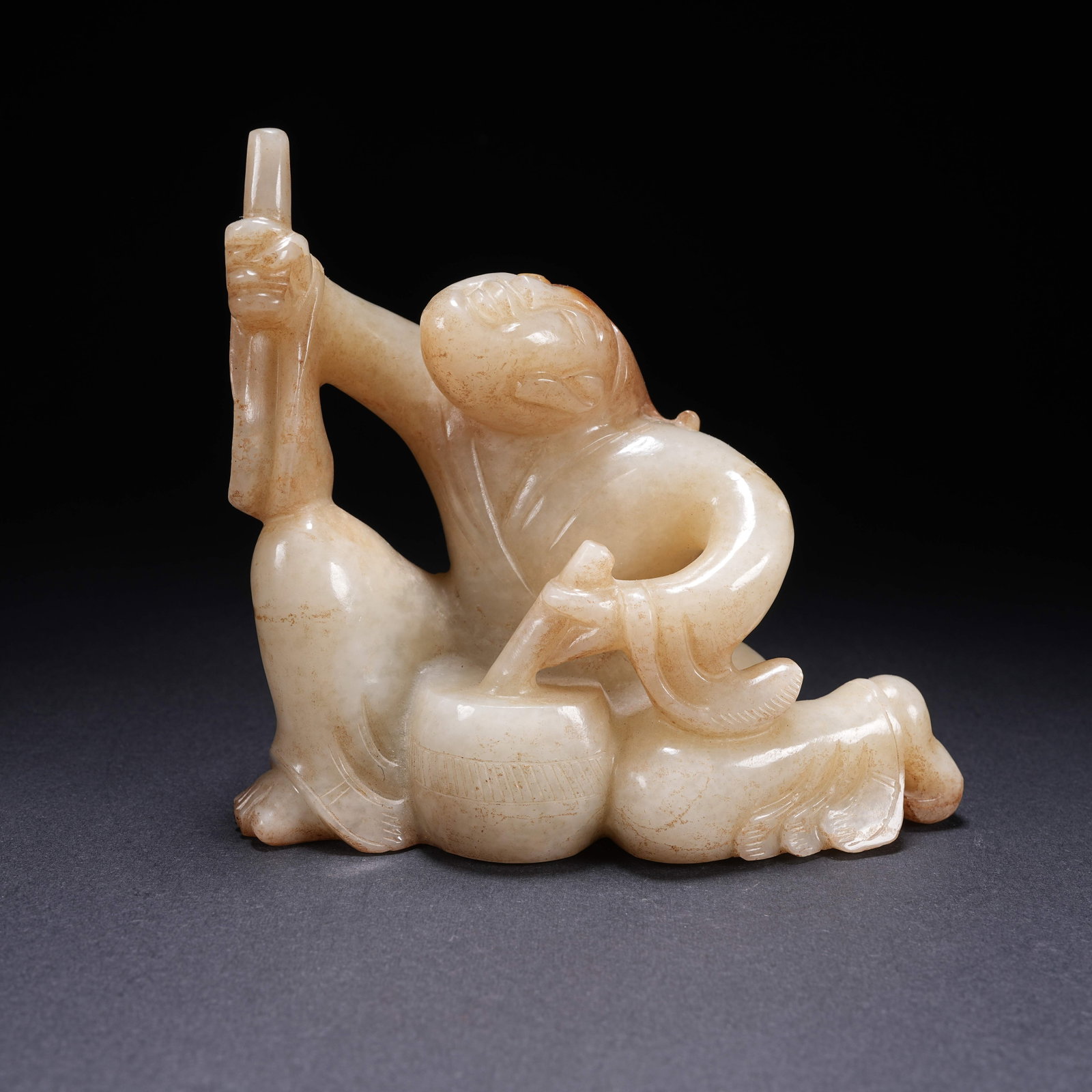 A HETIAN JADE DRUMMING FIGURINE (1 of 8)