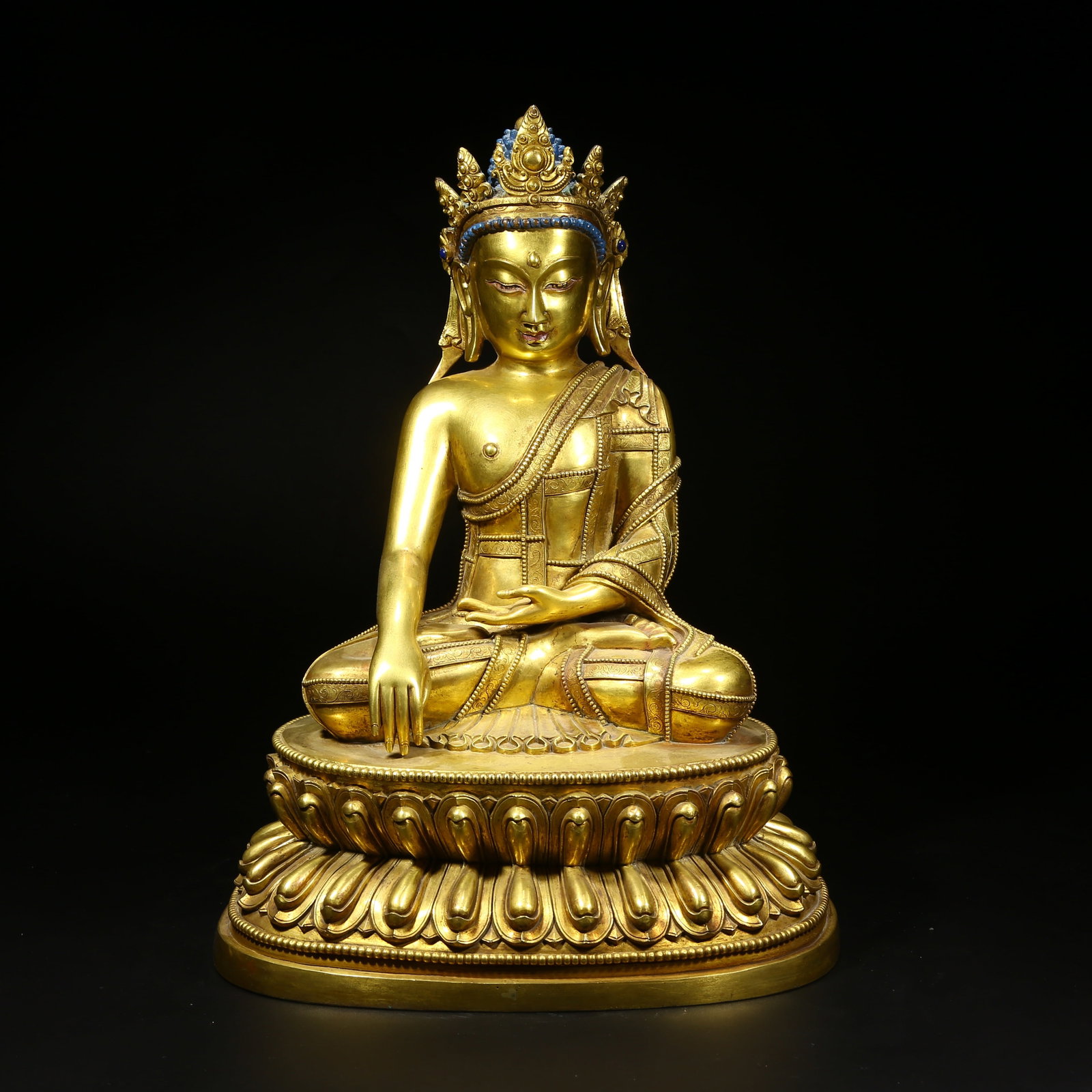 A GILT BRONZE STATUE OF SHAKYAMUNI BUDDHA WITH JEWELED CROWN: Gilt bronze statue of Shakyamuni Buddha with jeweled crown