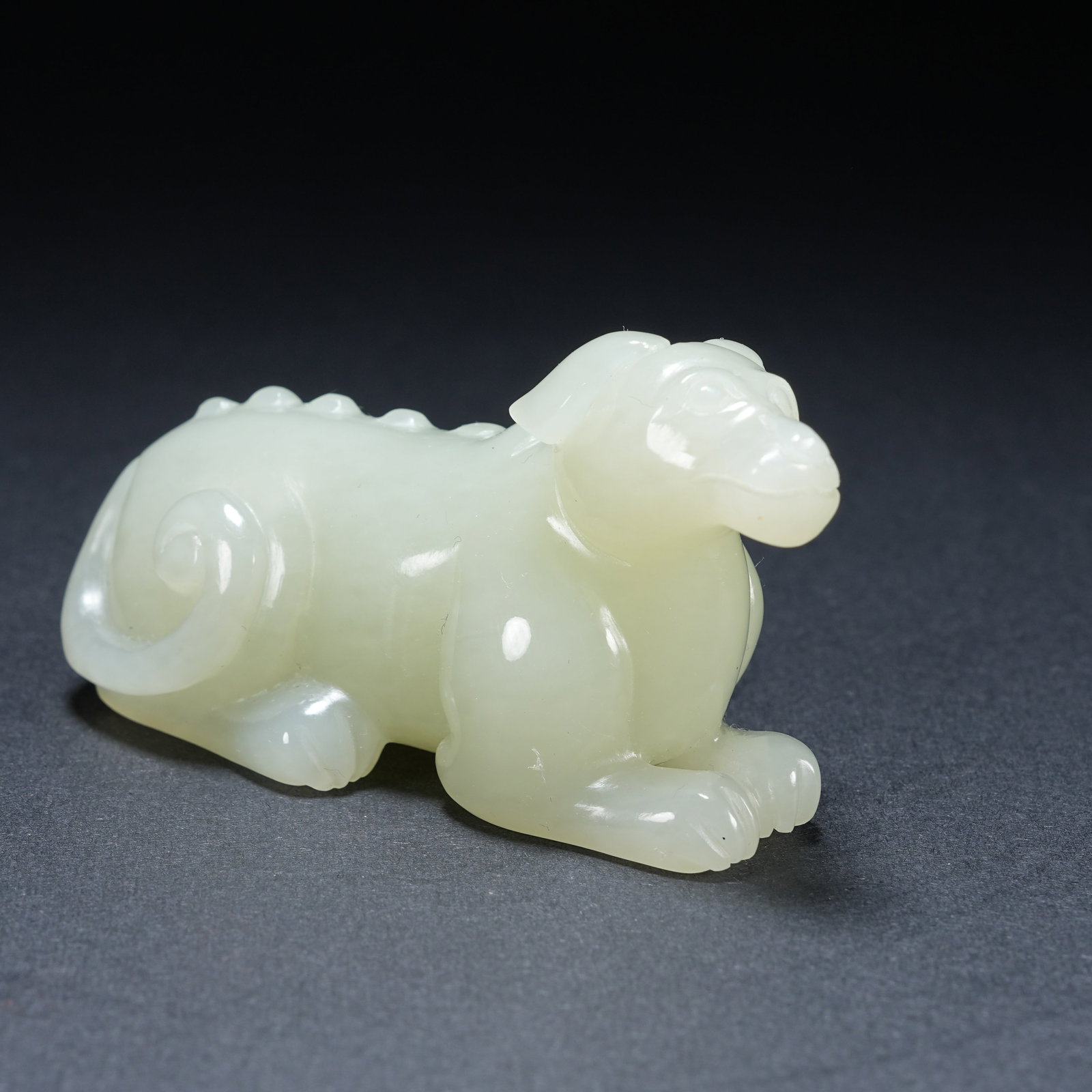 A HETIAN JADE SPIRIT DOG HANDHELD ORNAMENT: Hetian Jade Spirit Dog Handheld Ornament