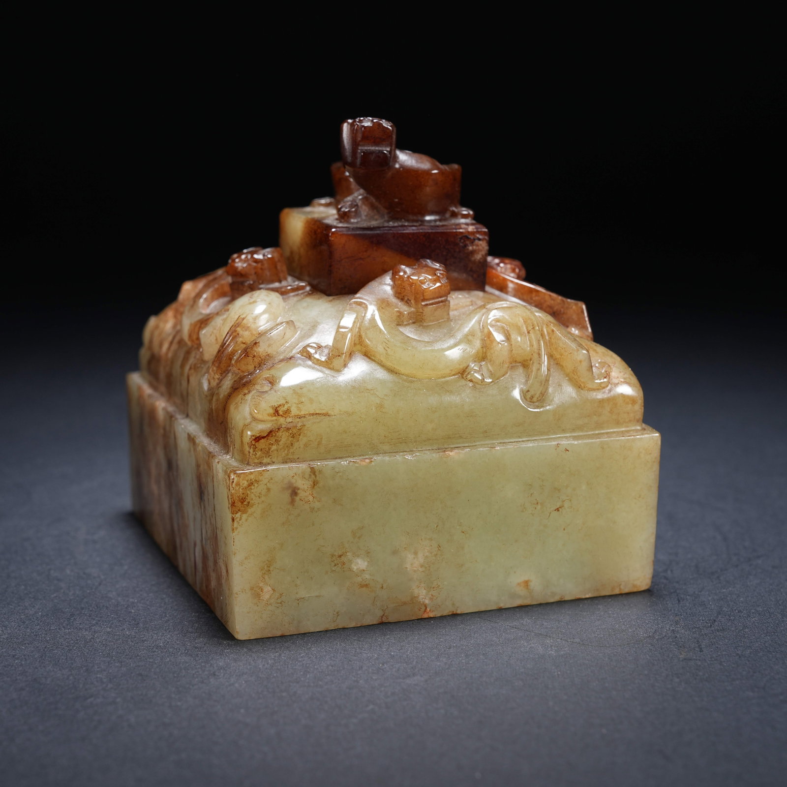A ARCHAIC JADE FOUR-DRAGON SEAL WITH UPPER DRAGON SEAL: Archaic jade four-dragon seal with upper dragon seal