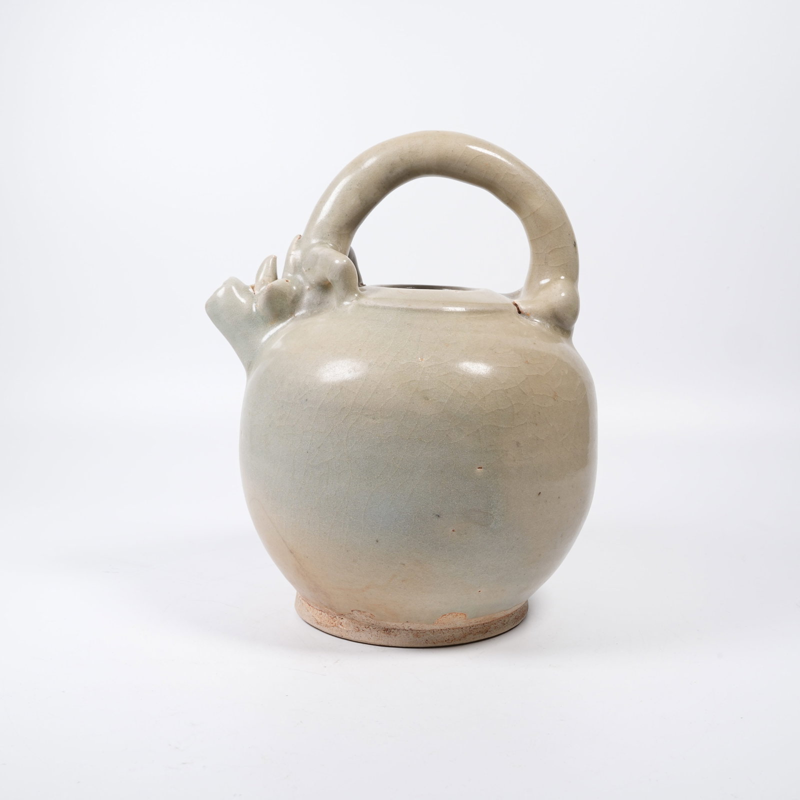 A CELADON EWER WITH BEAST-HEAD SPOUT AND HOOP HANDLE: Celadon Ewer with Beast-head Spout and Hoop Handle