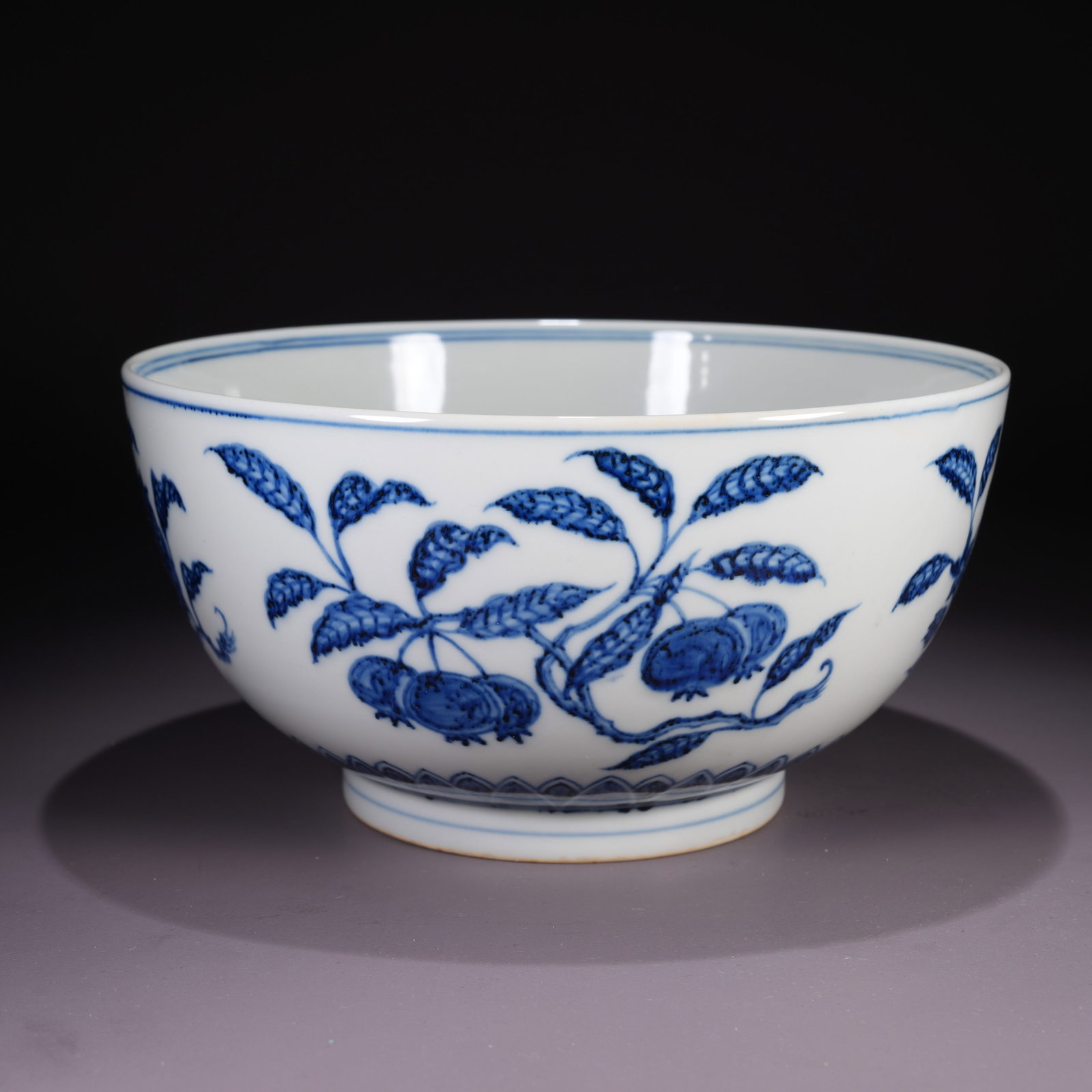 A LARGE BLUE-AND-WHITE BOWL WITH AUSPICIOUS FRUIT MOTIF (1 of 9)