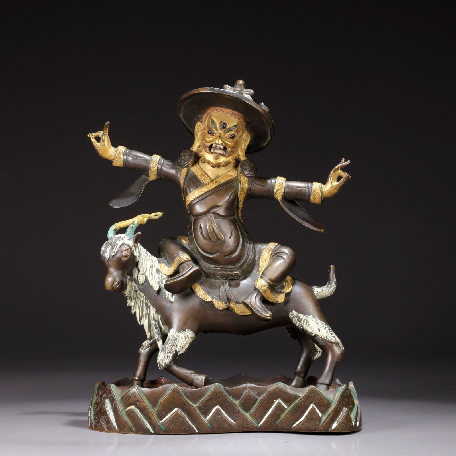 A GILDED BRONZE PROTECTOR DEITY STATUE (1 of 8)