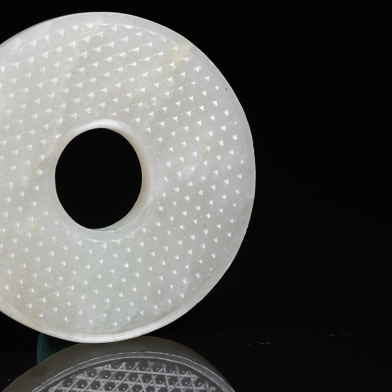 A NEPHRITE BI DISC WITH STUD PATTERN - 2