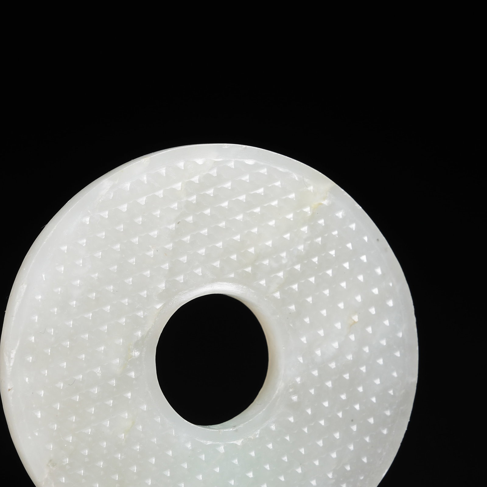 A NEPHRITE BI DISC WITH STUD PATTERN - 4