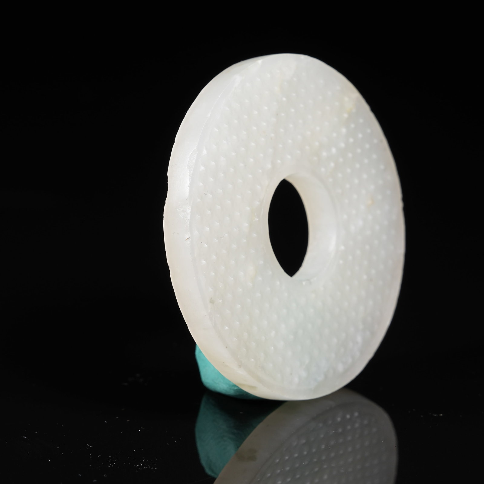 A NEPHRITE BI DISC WITH STUD PATTERN - 5