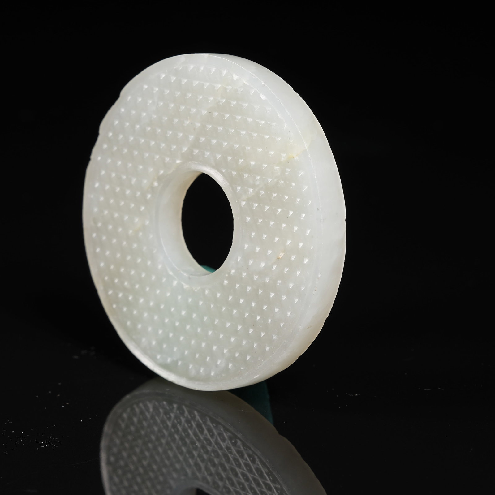 A NEPHRITE BI DISC WITH STUD PATTERN - 6