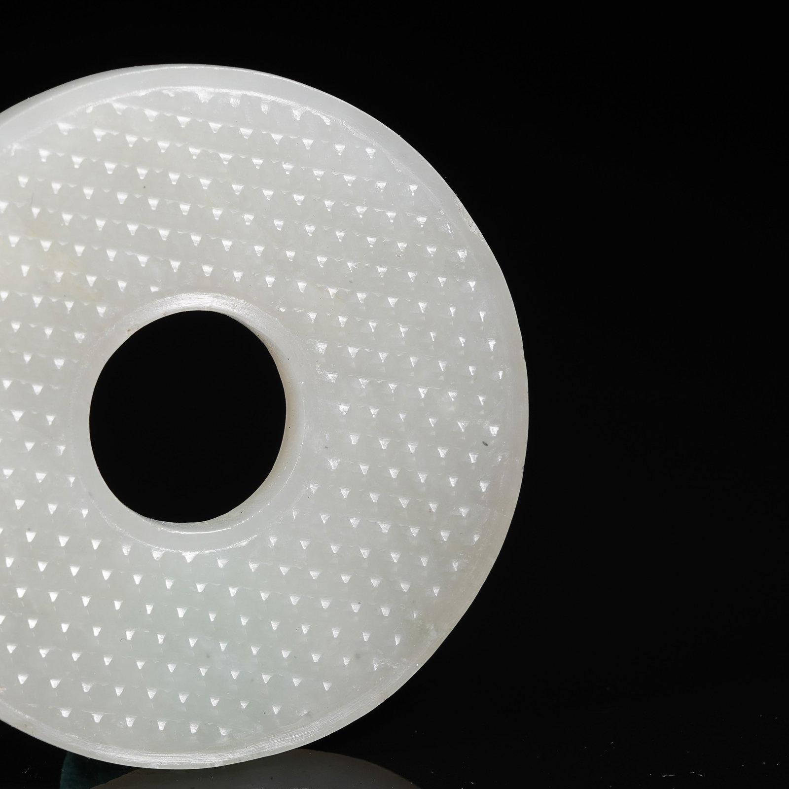 A NEPHRITE BI DISC WITH STUD PATTERN - 7