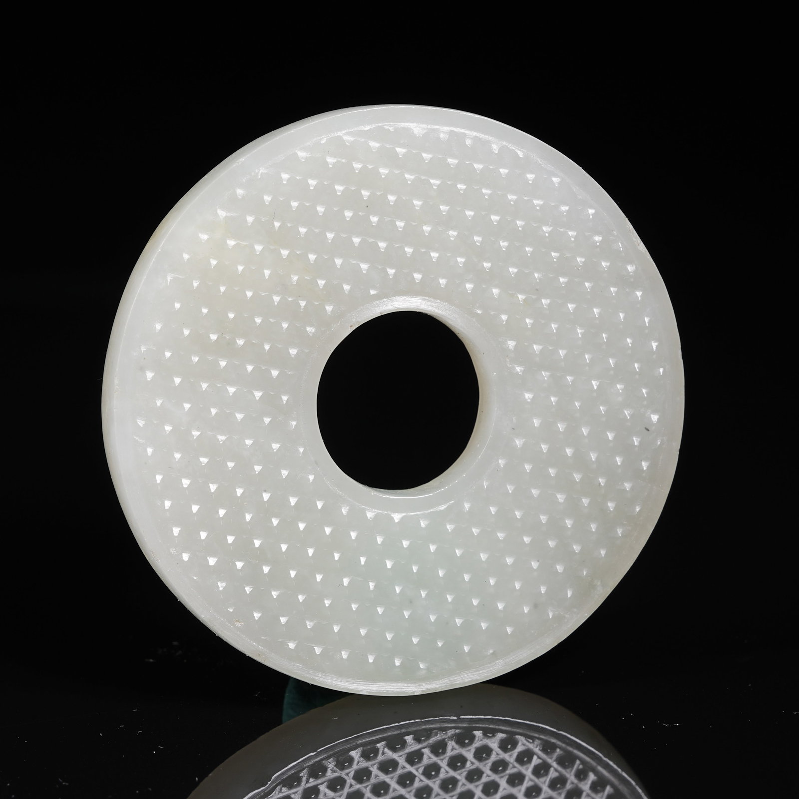 A NEPHRITE BI DISC WITH STUD PATTERN - 8