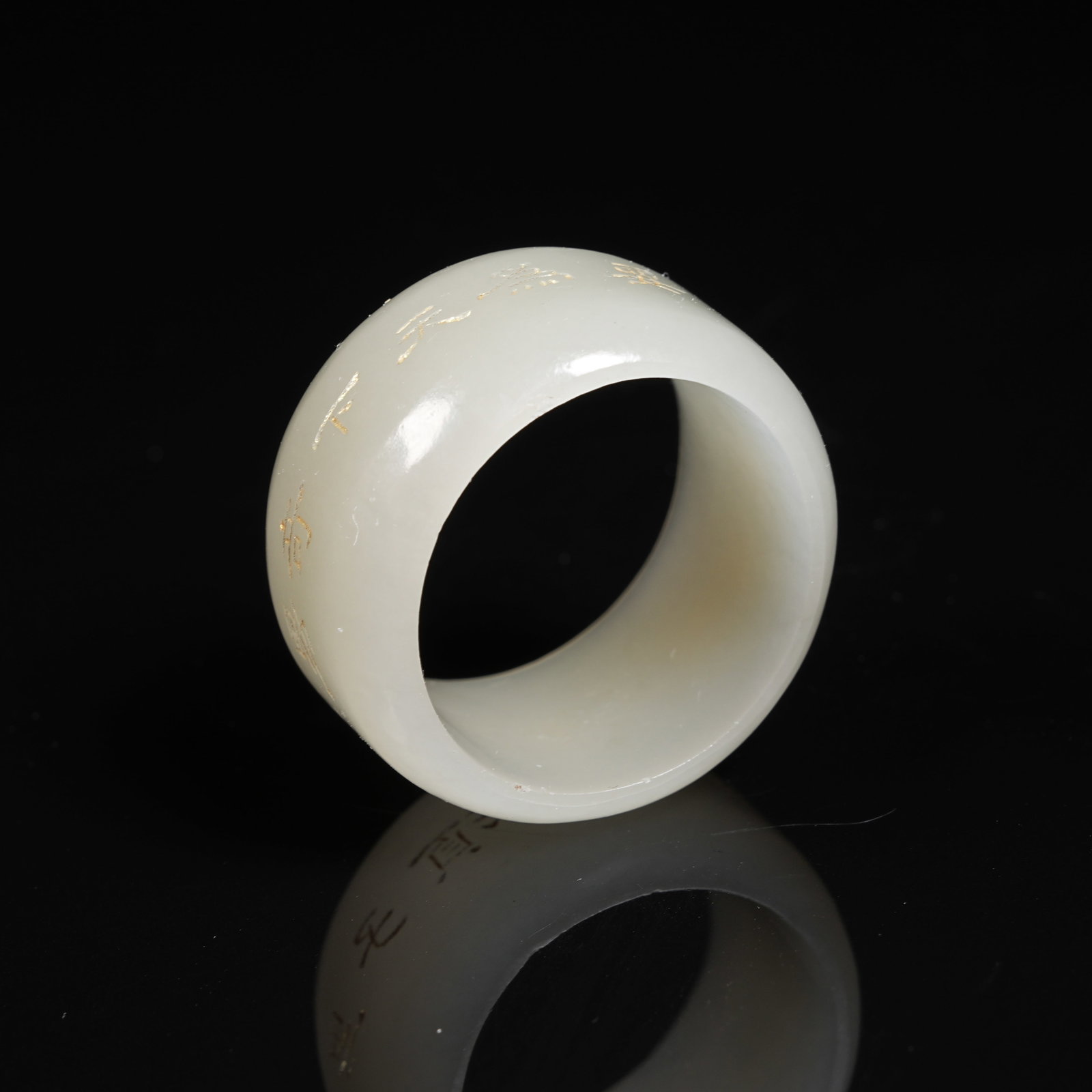 A GILDED INSCRIBED NEPHRITE RING - 9