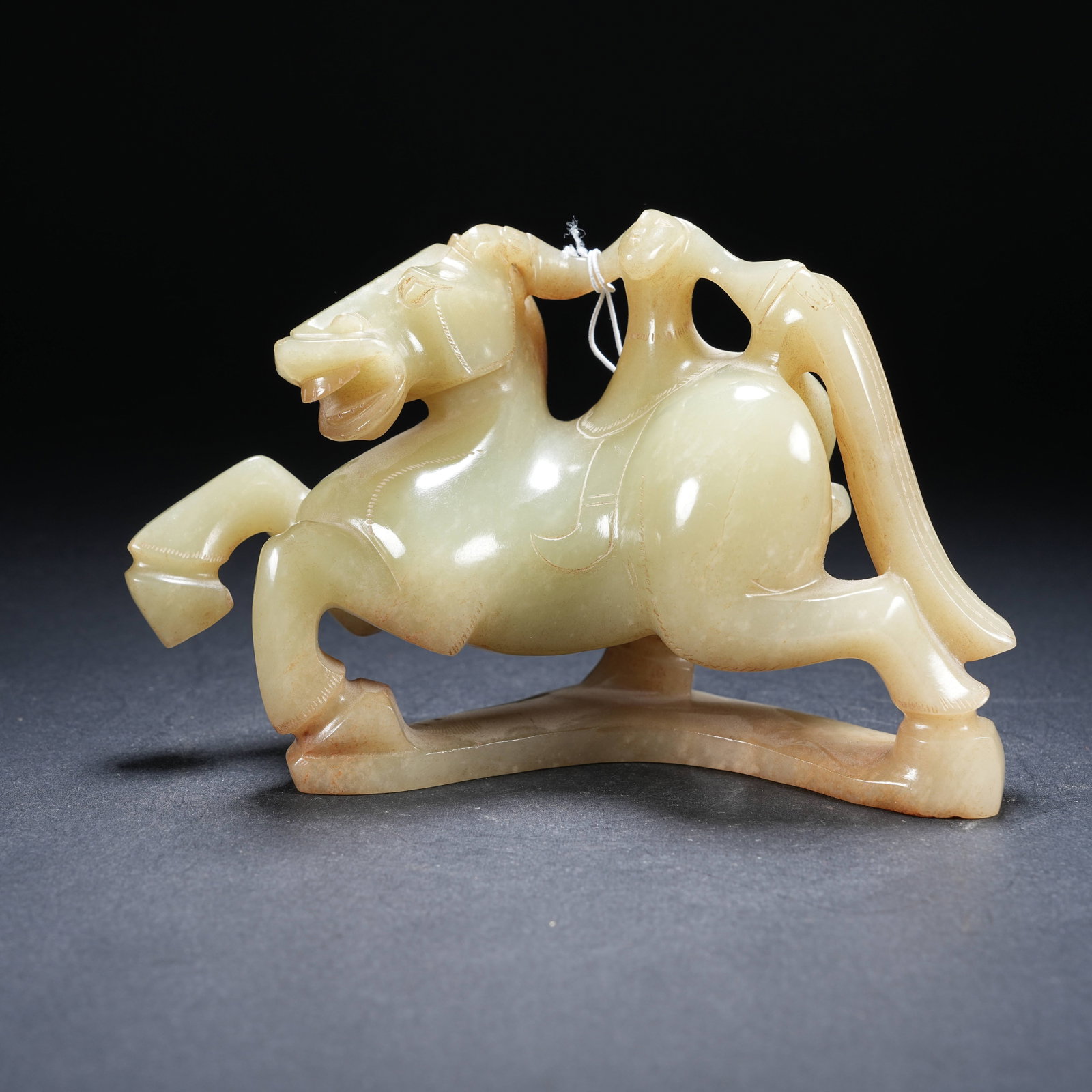 A ARCHAIC JADE FIGURINE OF HUMAN RIDING BEAST (1 of 8)