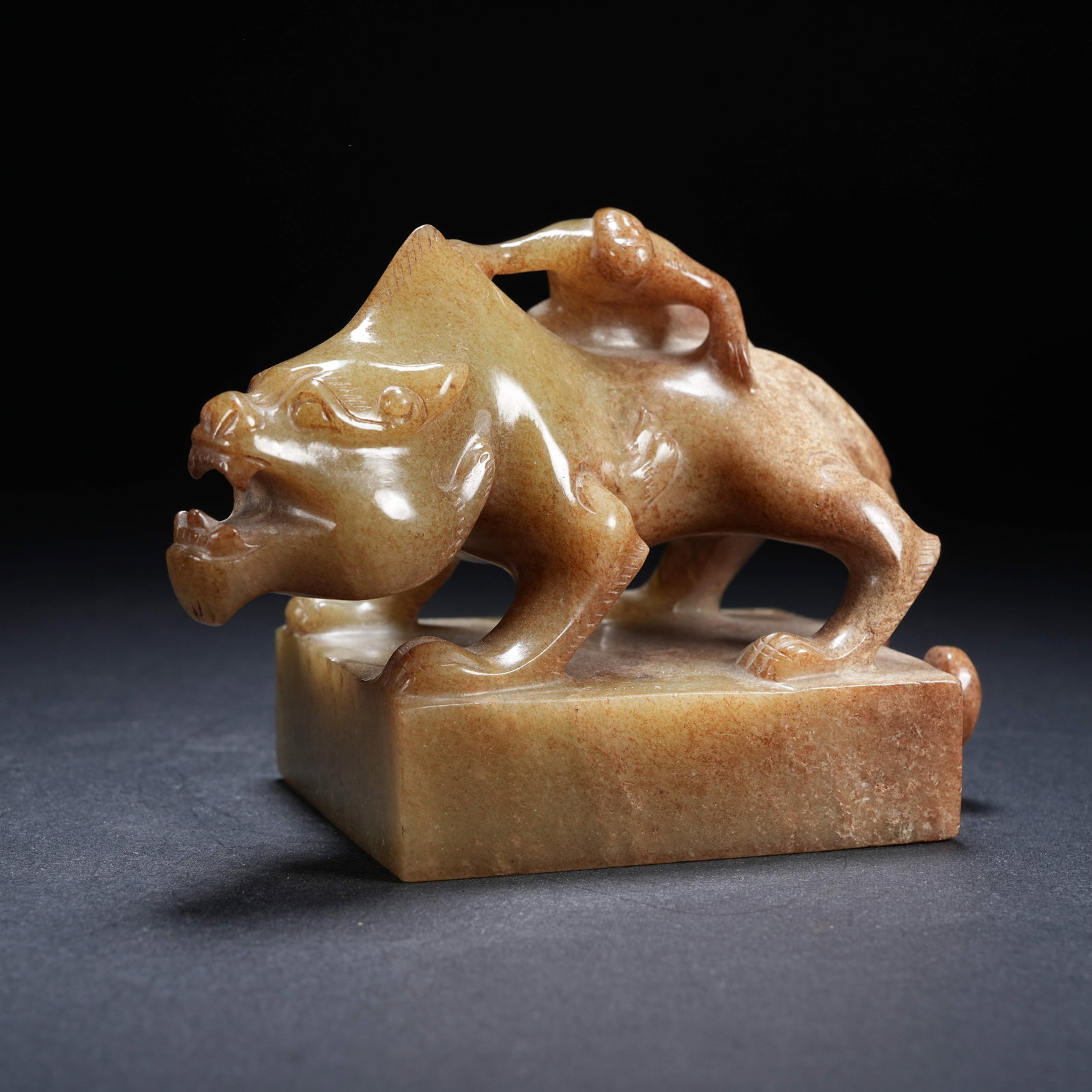 A ARCHAIC JADE SEAL WITH FEATHERED MAN RIDING BEAST KNOB: Archaic Jade Seal with Feathered Man Riding Beast knob