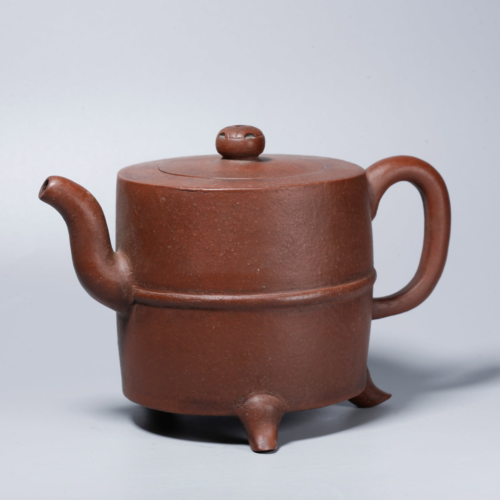 A ZISHA CARVED TRIPOD EWER: Zisha Carved Tripod Ewer