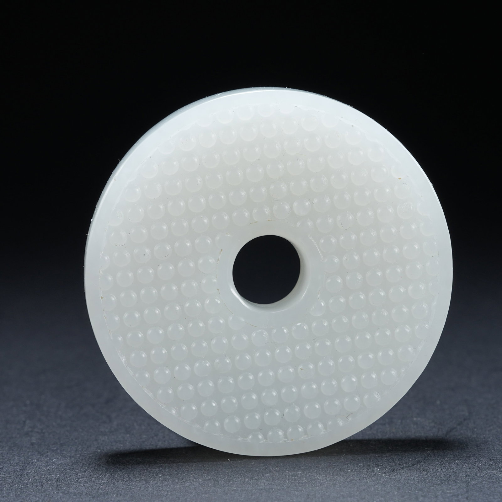 A HETIAN JADE ROUND BI DISC WITH NAIL BOSS PATTERN: Hetian Jade Round Bi Disc with Nail Boss Pattern