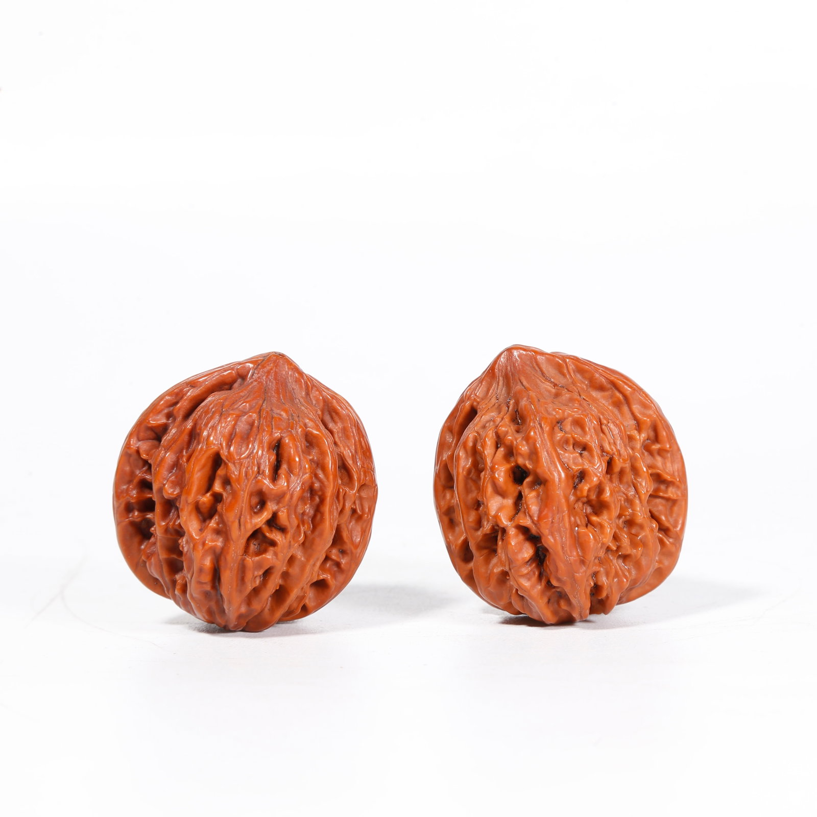 A WALNUT ORNAMENTS (PAIR): Walnut Ornaments (Pair)