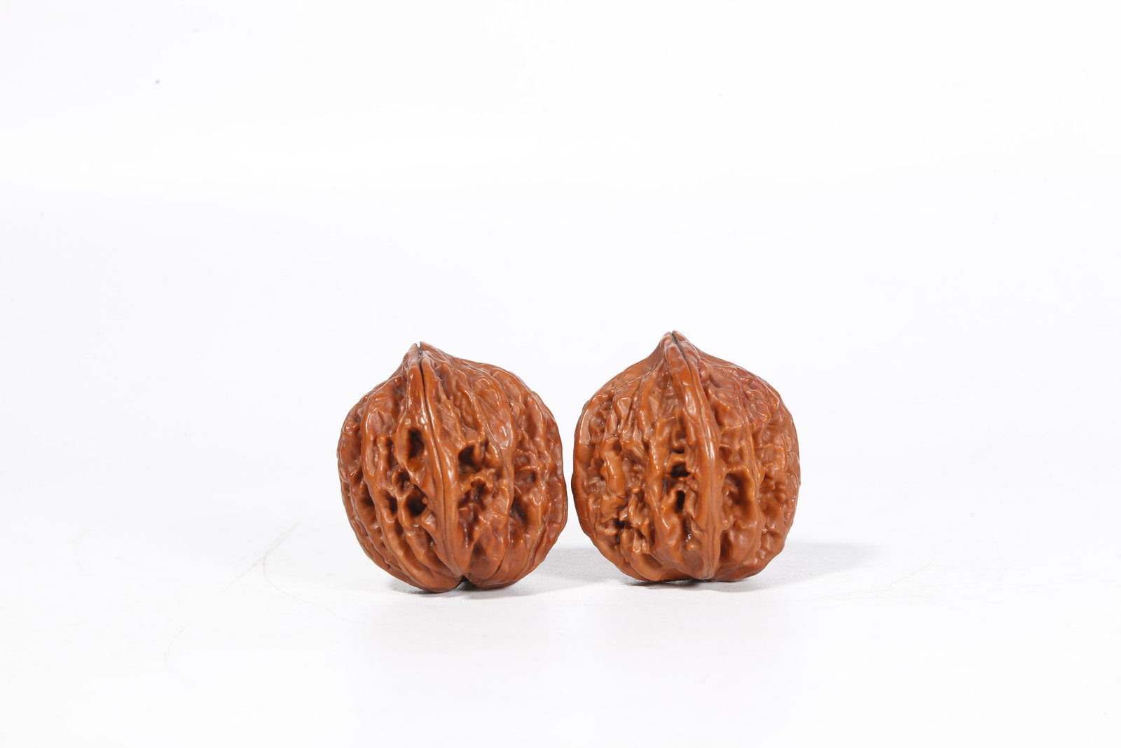 A WALNUT ORNAMENTS (PAIR) - 2