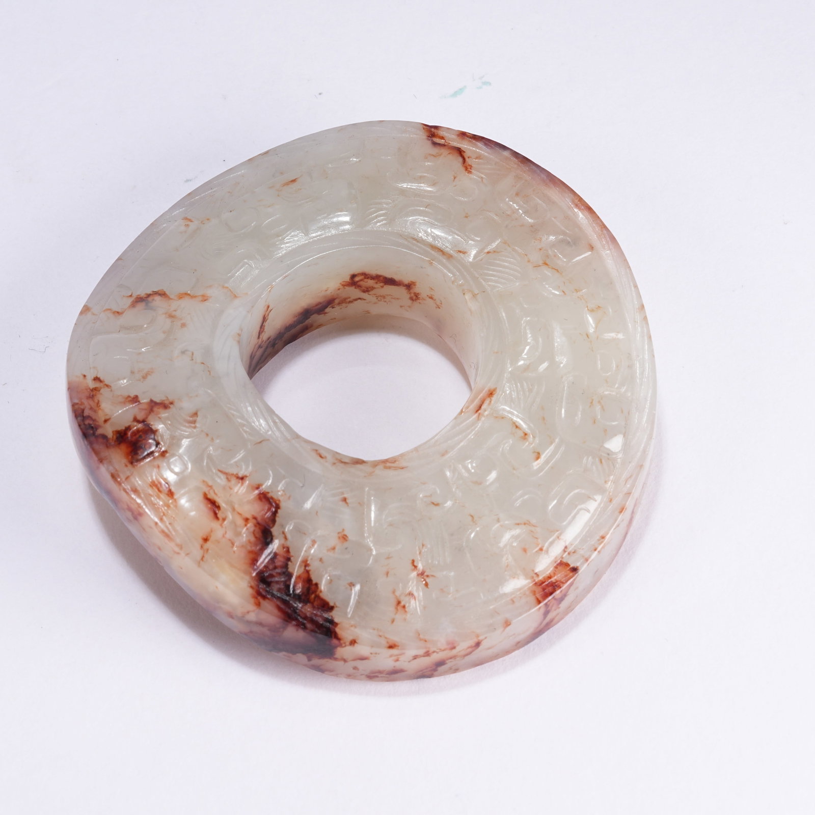 A ANCIENT JADE RING WITH CLOUD SCROLL PATTERN: Ancient Jade Ring with Cloud Scroll Pattern