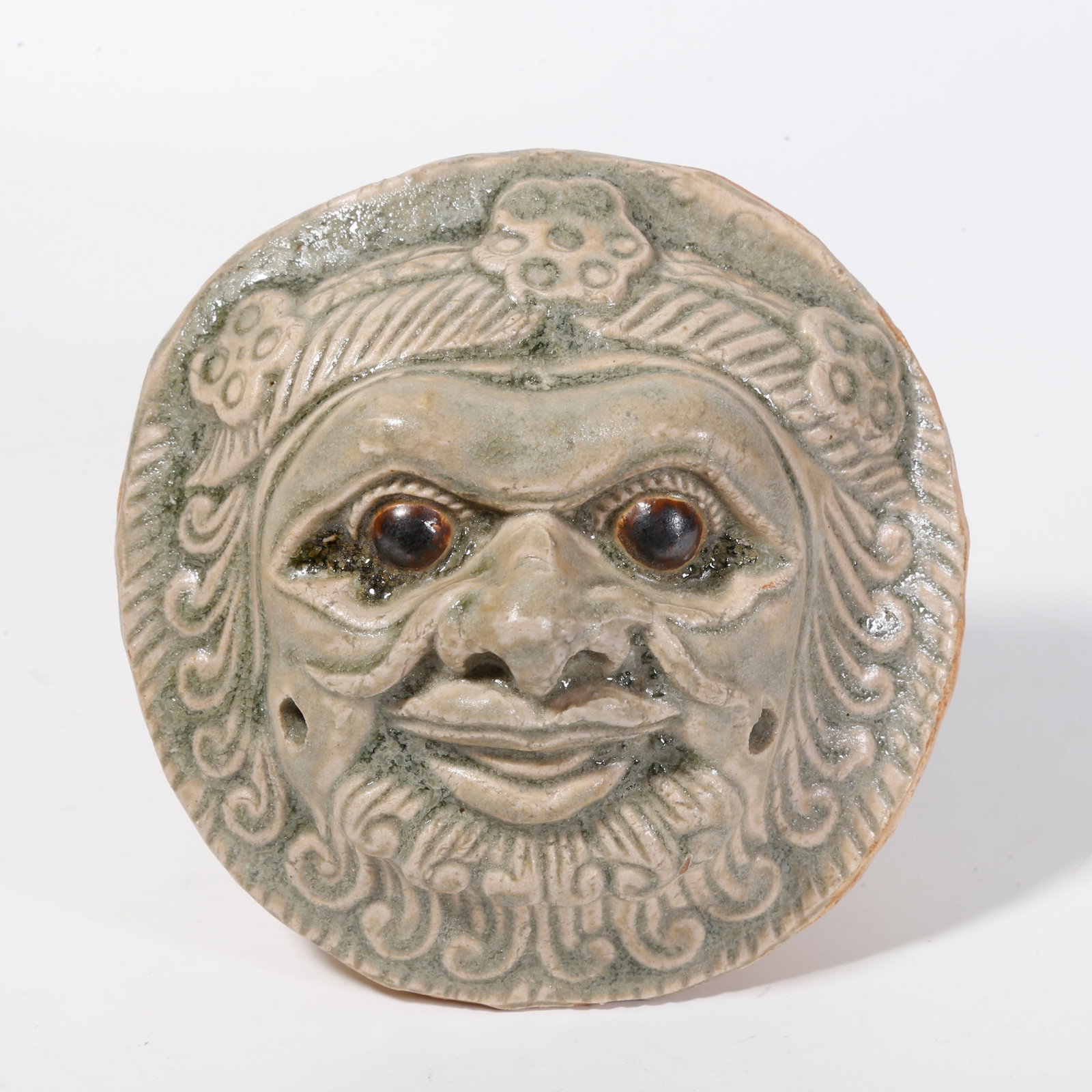 A CELADON HU PEOPLE FACE ORNAMENT (1 of 9)