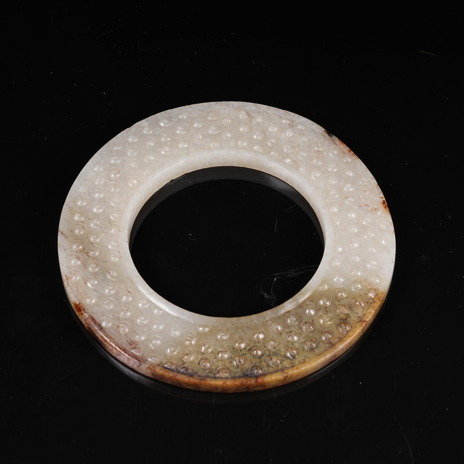 A ARCHAIC JADE BI DISC WITH INTERLOCKING CLOUD PATTERN: Archaic Jade Bi Disc with Interlocking Cloud Pattern