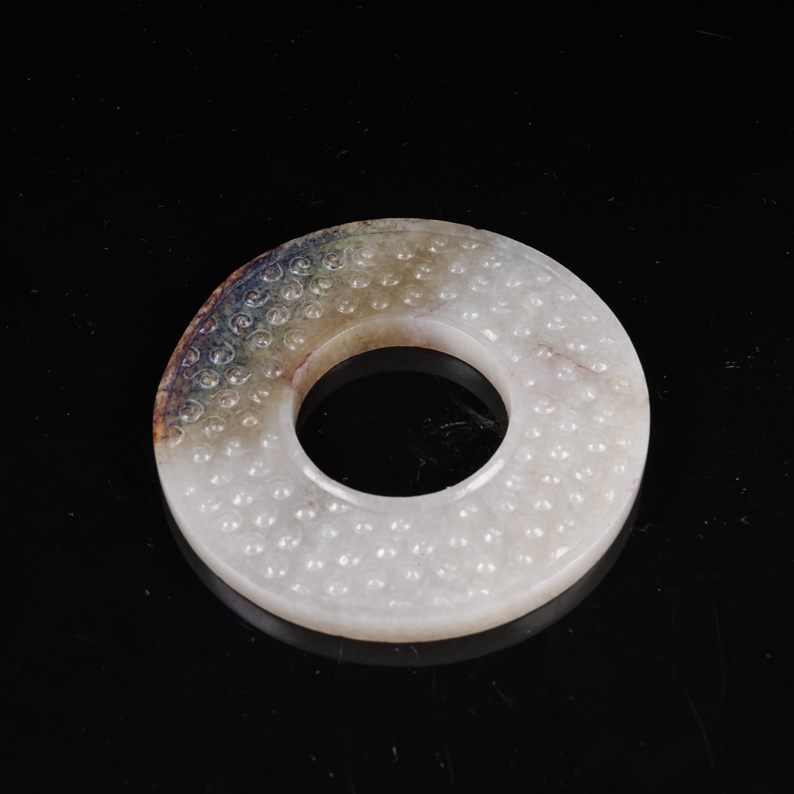 A ARCHAIC JADE BI DISC WITH INTERLOCKING CLOUD PATTERN: Archaic Jade Bi Disc with Interlocking Cloud Pattern