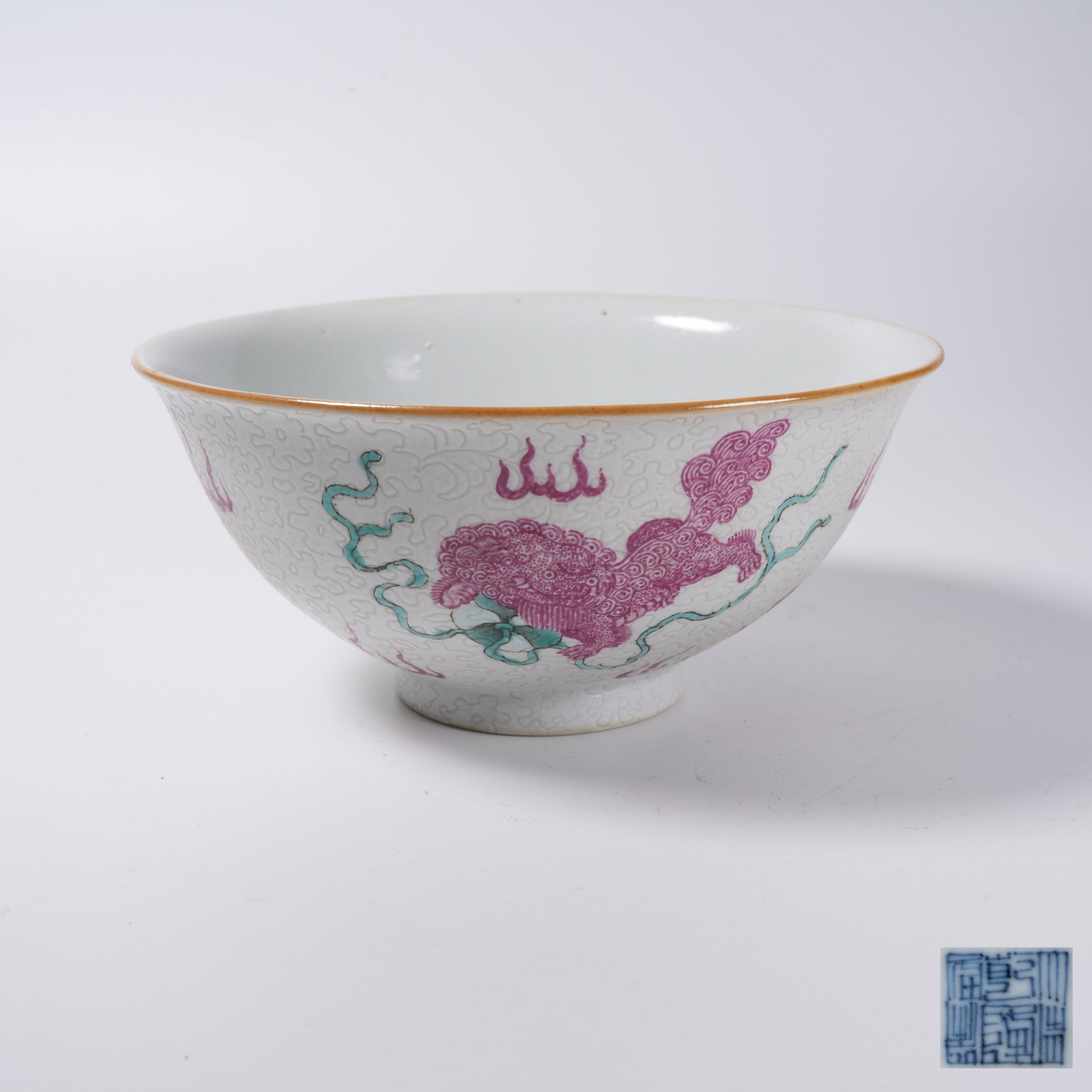 A ROUGE RED GLAZED PLATE WITH LIONS PLAYING WITH EMBROIDERED BALL PATTERN: Rouge Red Glazed Plate with Lions Playing with Embroidered Ball Pattern