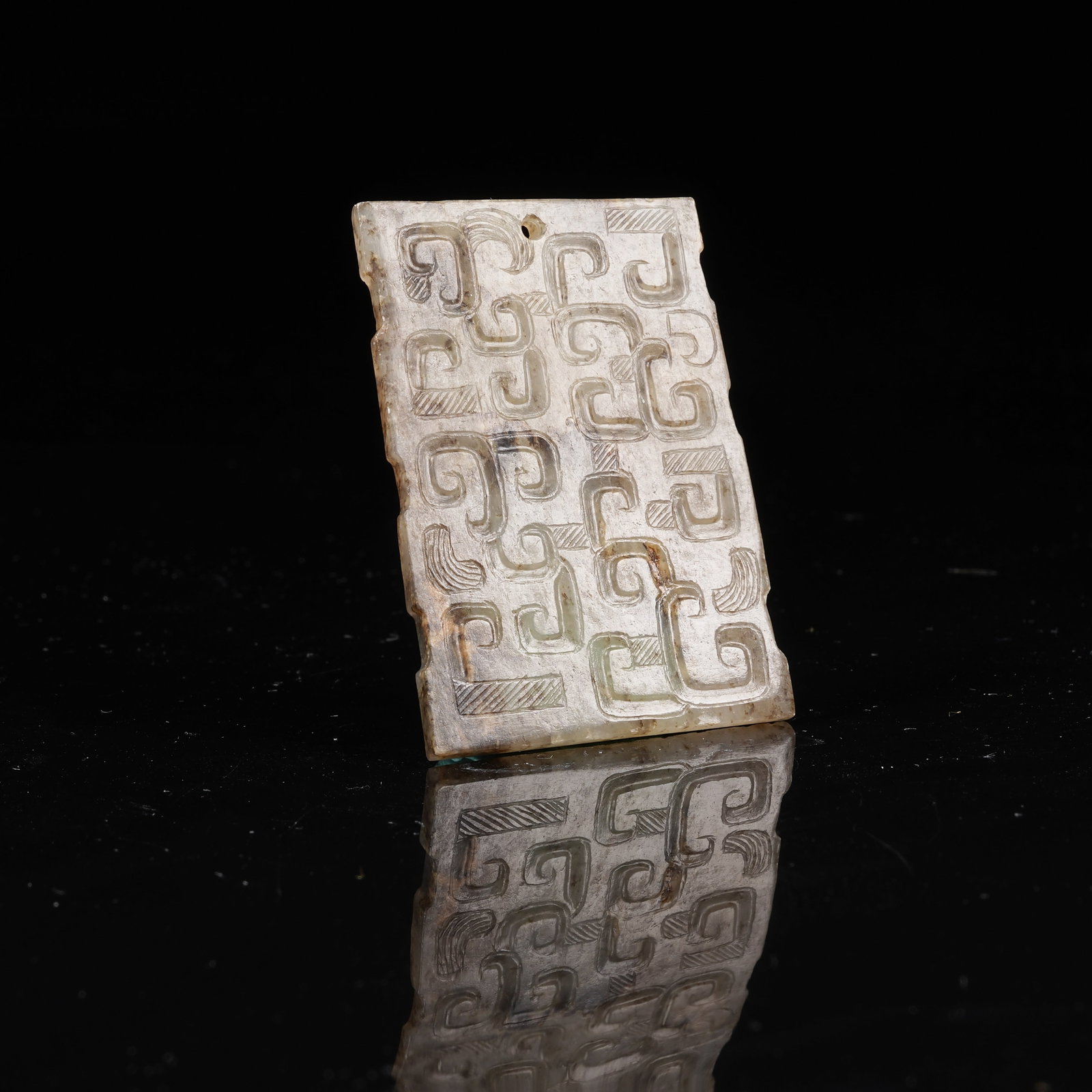 A ARCHAIC JADE PENDANT WITH INTERLOCKING CLOUD PATTERN: Archaic Jade Pendant with Interlocking Cloud Pattern