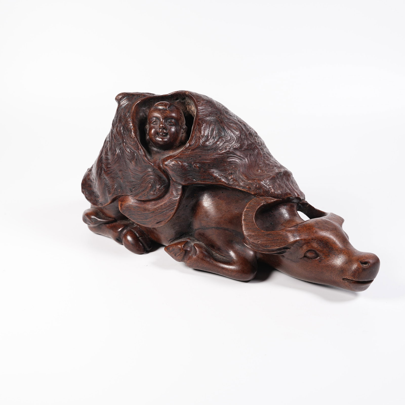 A HUANGHUALI WOOD ORNAMENT OF BOY HERDING OX: Huanghuali Wood Ornament of Boy Herding Ox