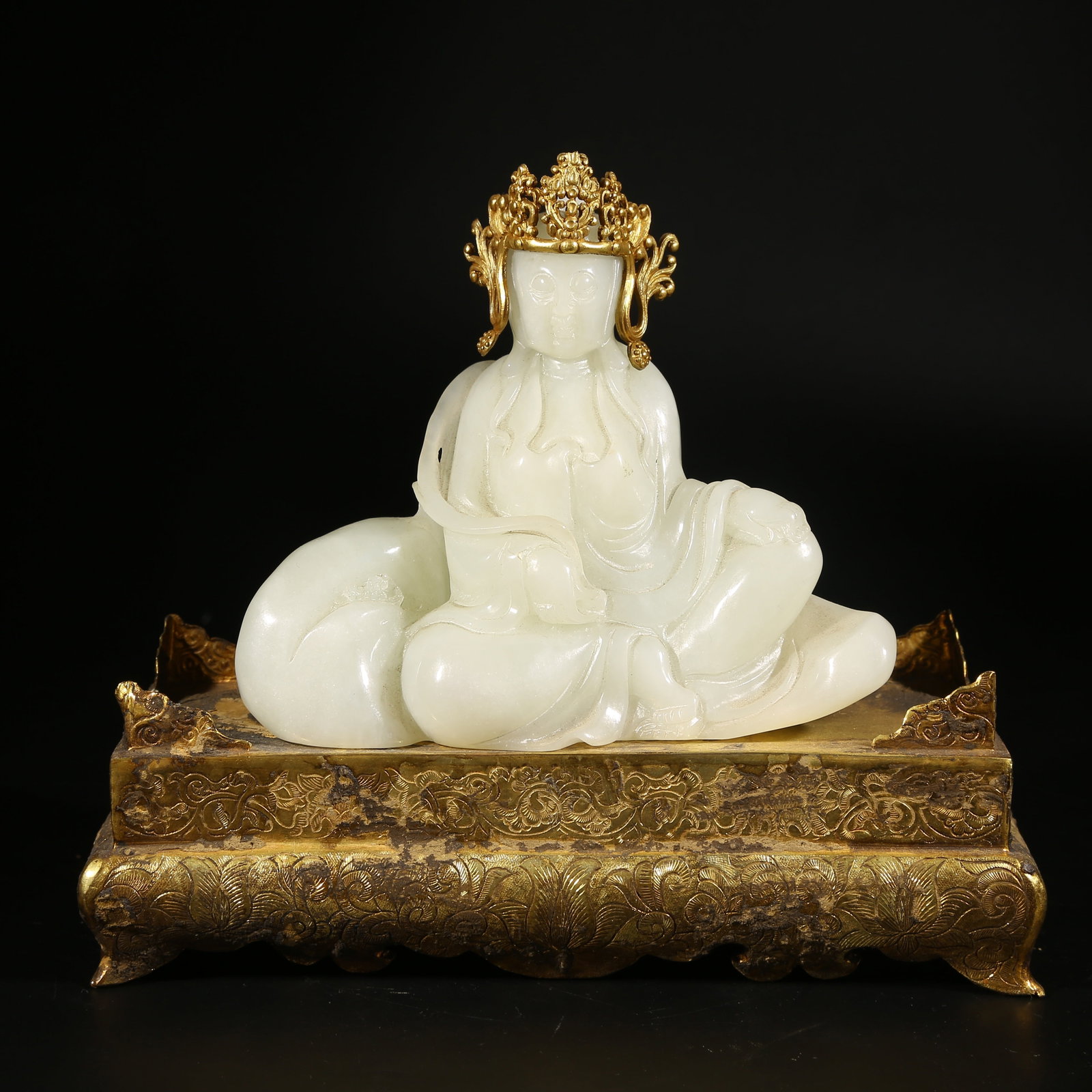 A HETIAN WHITE JADE GUANYIN FIGURE WITH GILT BRONZE BASE: Hetian White Jade Guanyin Figure with Gilt Bronze Base
