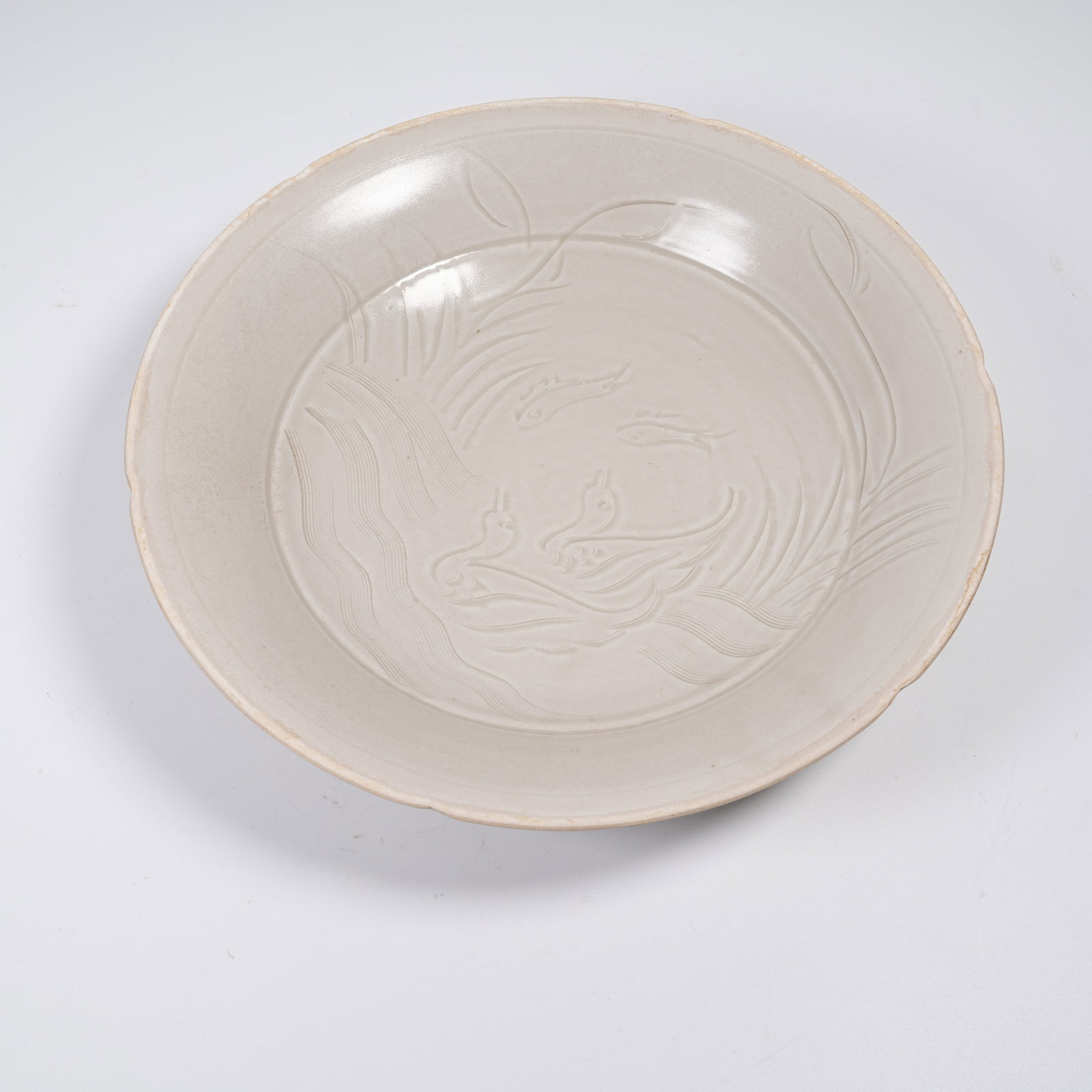 A DINGYAO PLATE WITH LOTUS POND SCENERY PATTERNS: Dingyao Plate with Lotus Pond Scenery Patterns