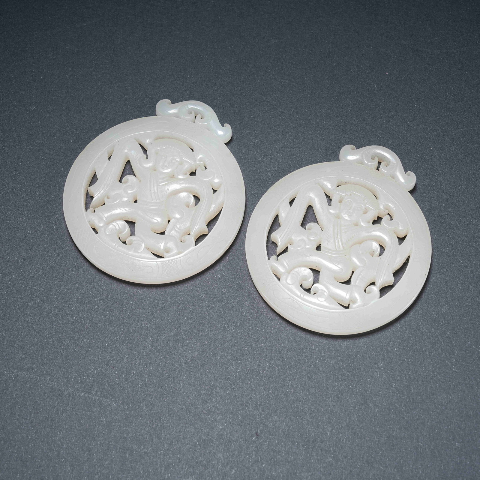 A SET OF OPENWORK CARVED HETIAN JADE DANCER ORNAMENTS: Set of Openwork Carved Hetian Jade Dancer Ornaments