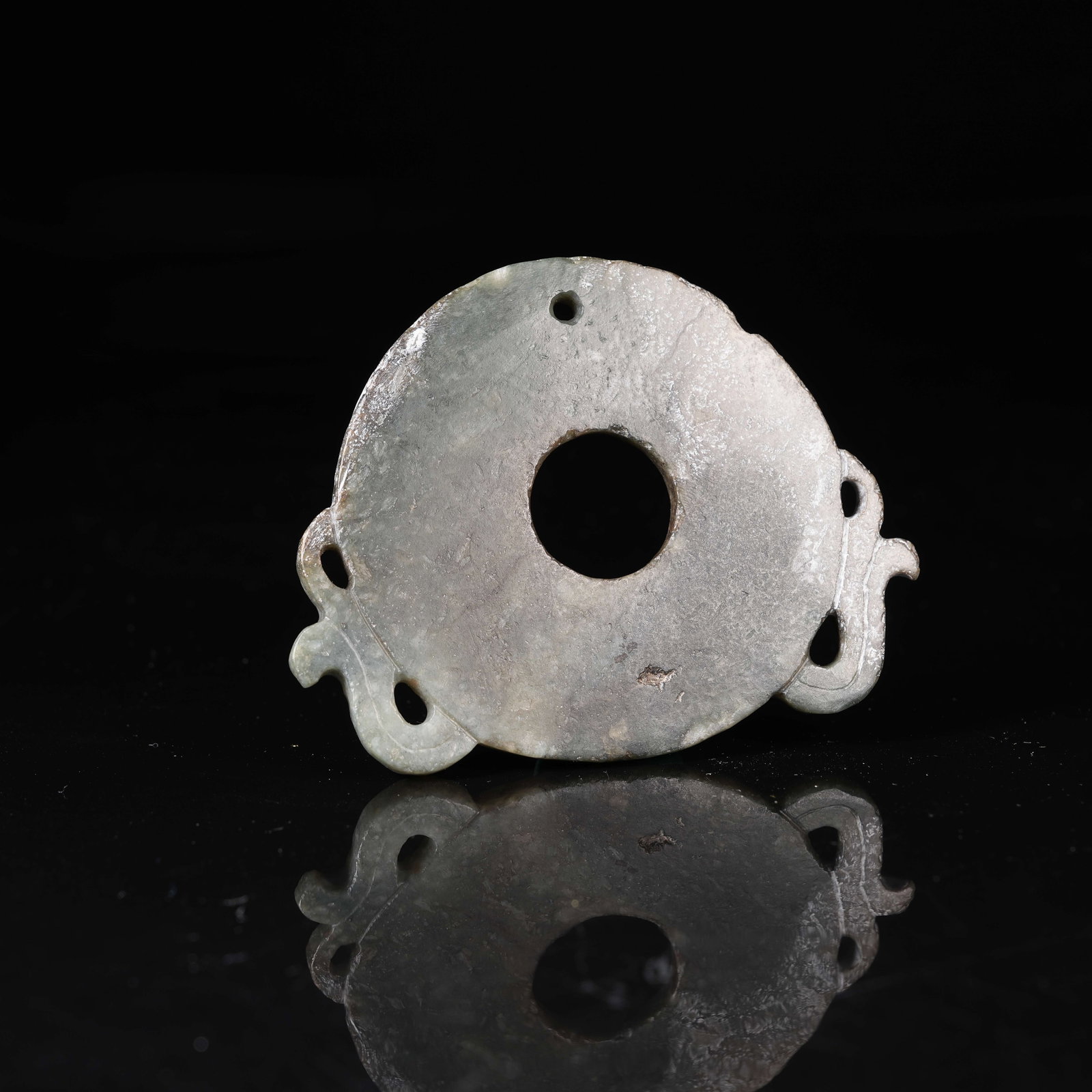 A GREEN NEPHRITE PIERCED BI DISC: Green Nephrite Pierced Bi Disc