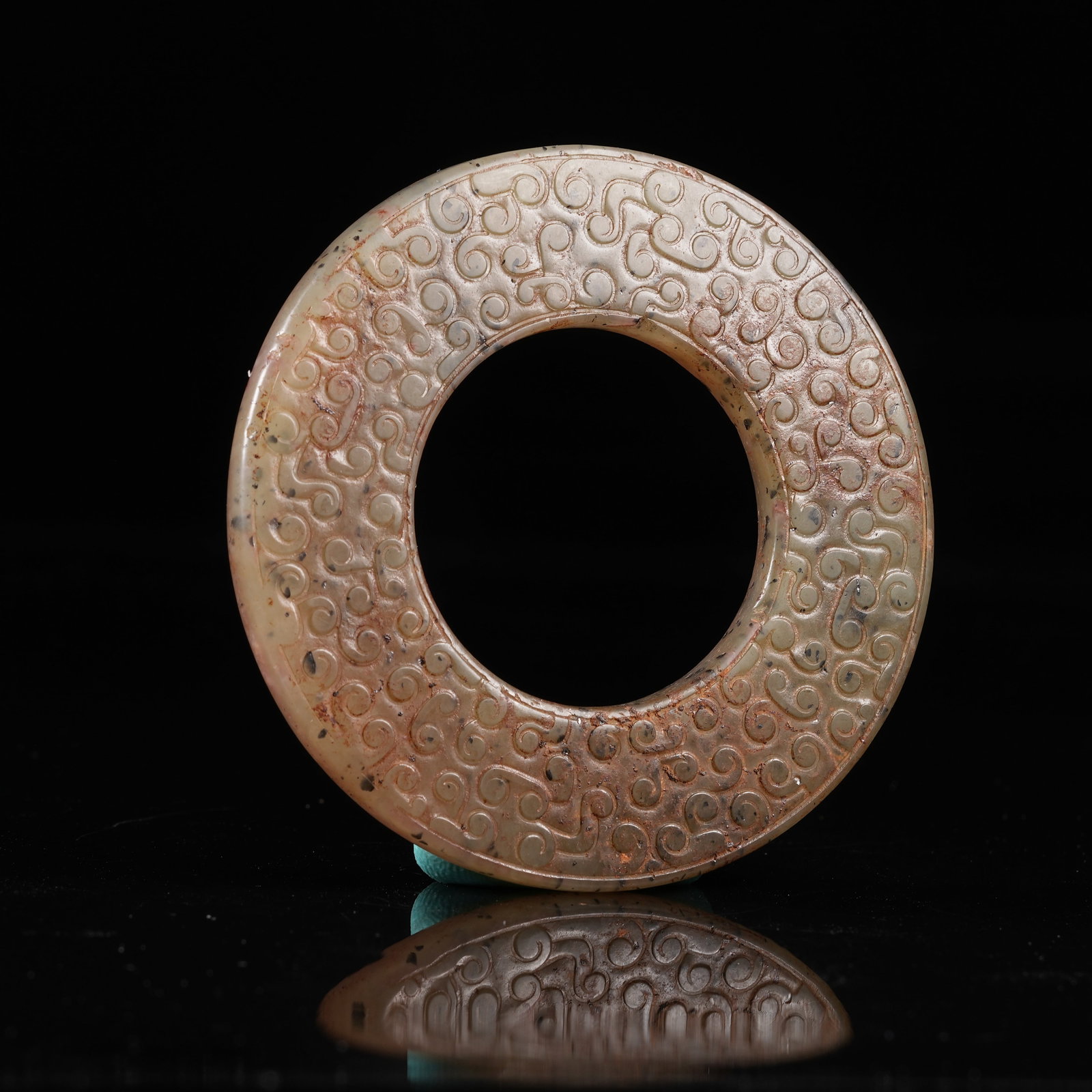 A ARCHAIC JADE BI DISC WITH INTERLOCKING CLOUD PATTERN: Archaic Jade Bi Disc with Interlocking Cloud Pattern