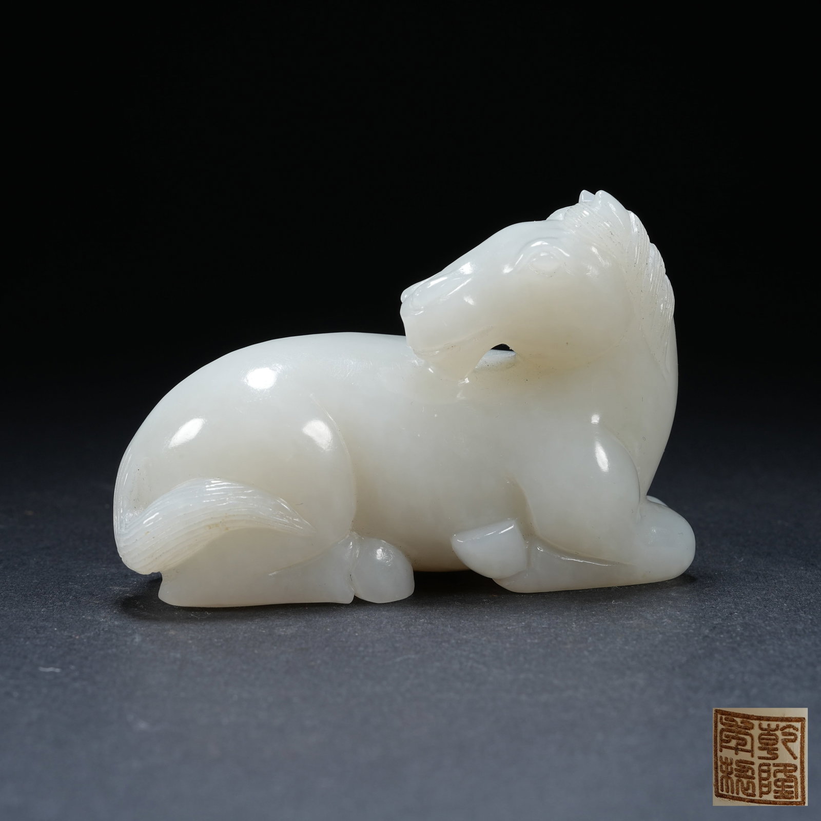 A HETIAN JADE RECUMBENT HORSE ORNAMENT: Hetian Jade Recumbent Horse Ornament