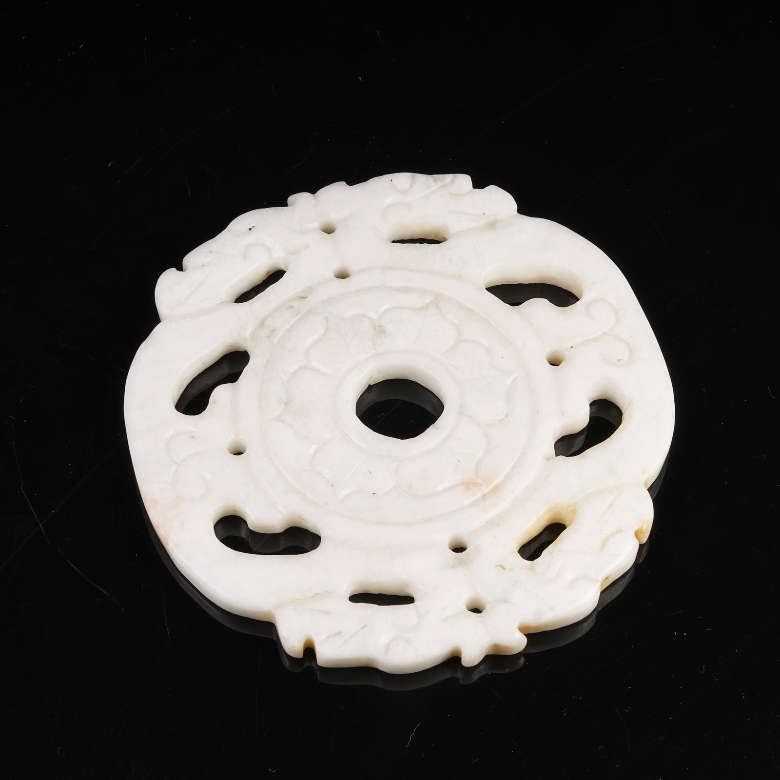 A ARCHAIC JADE FOUR-DRAGON PENDANT: Archaic Jade Four-Dragon Pendant