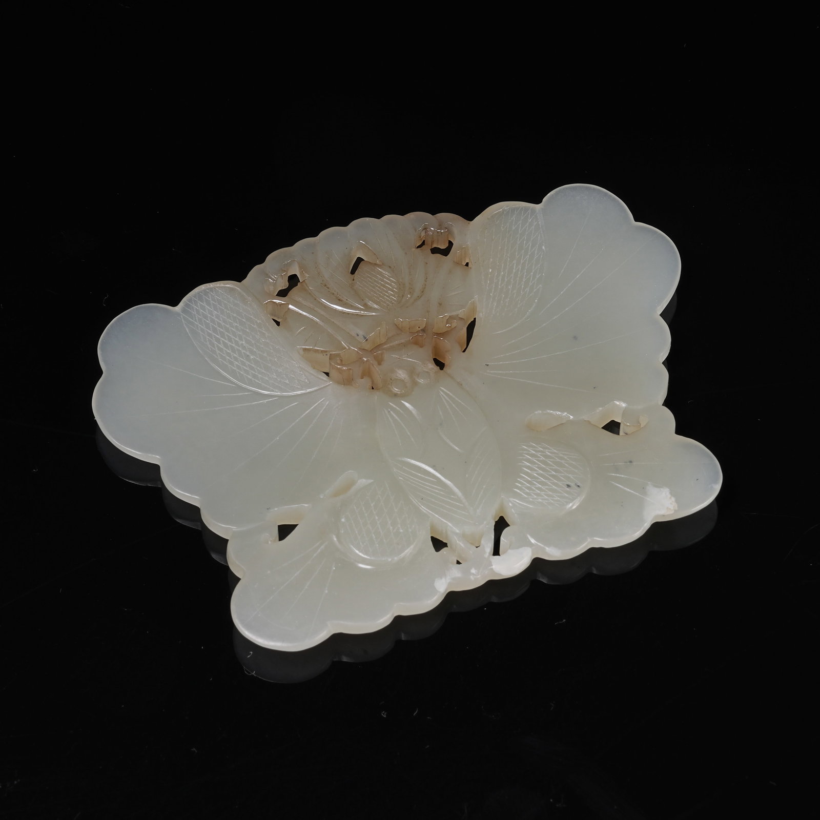 A NEPHRITE PENDANT WITH FLOWER AND BUTTERFLY MOTIF: Nephrite Pendant with Flower and Butterfly Motif