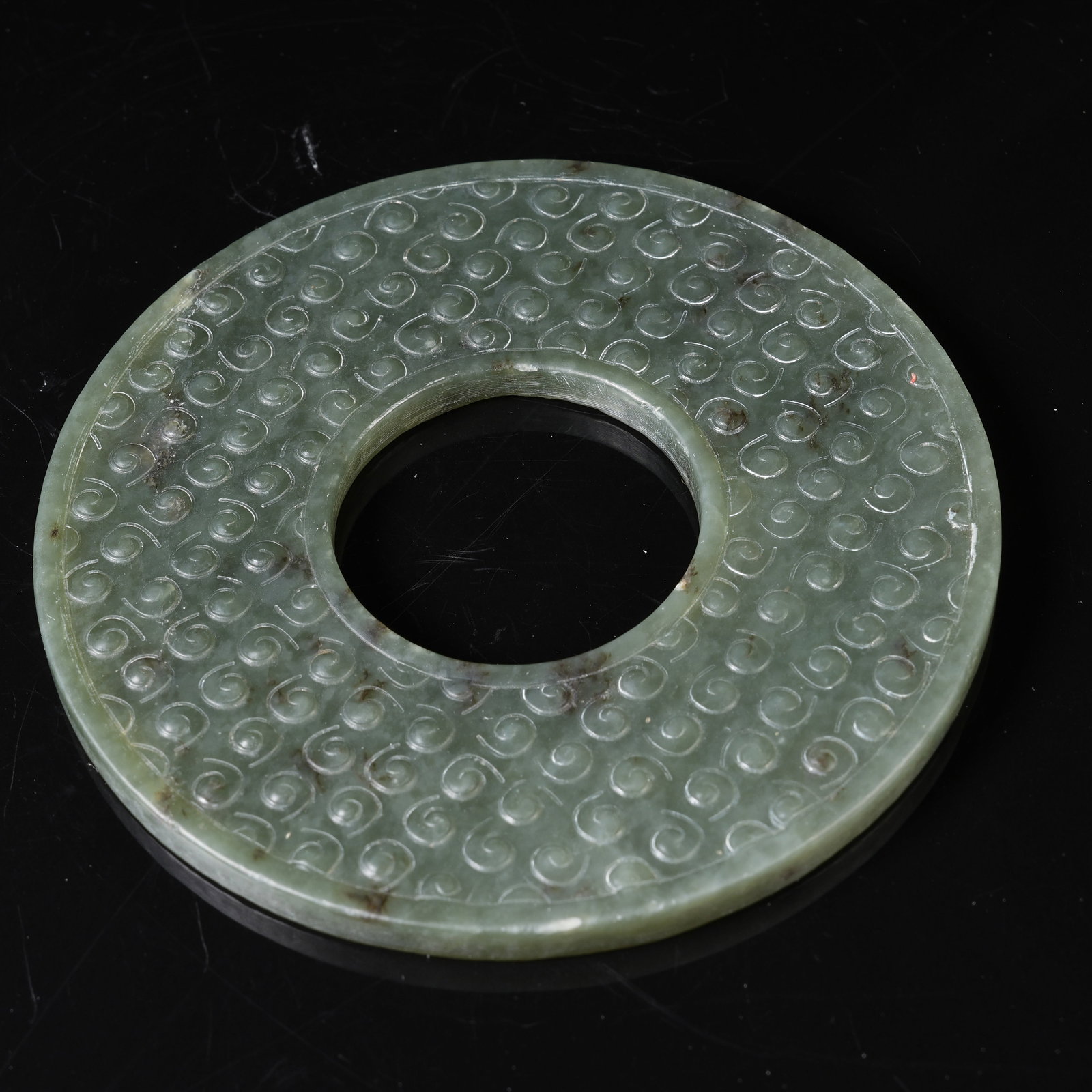 A GREEN NEPHRITE BI DISC WITH INTERLOCKING CLOUD PATTERN - 10