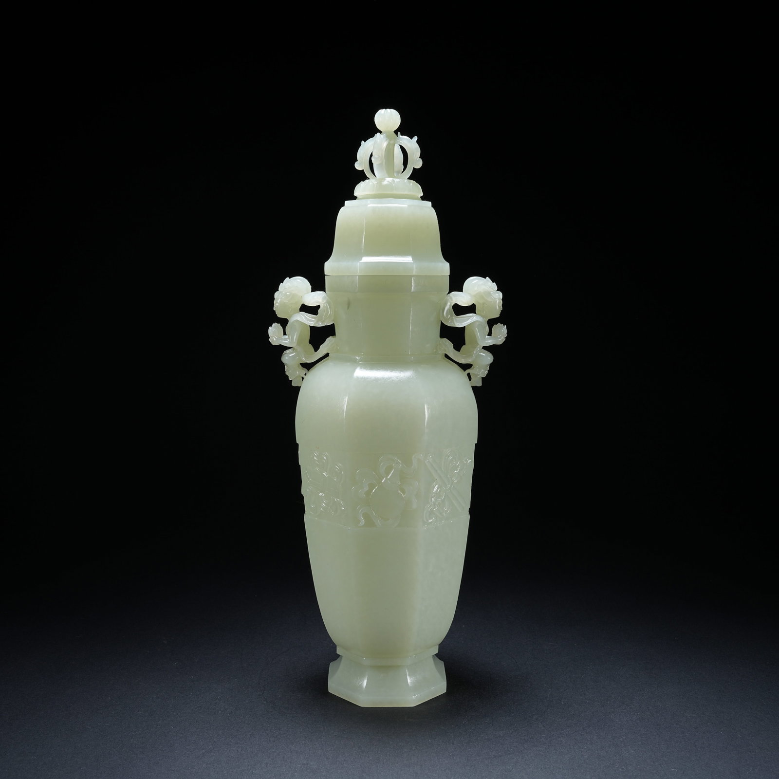 A HETIAN JADE OCTAGONAL VASE WITH DUAL FLYING APSARAS AND EIGHT TREASURES PATTERN: Hetian Jade Octagonal Vase with Dual Flying Apsaras and Eight Treasures Pattern