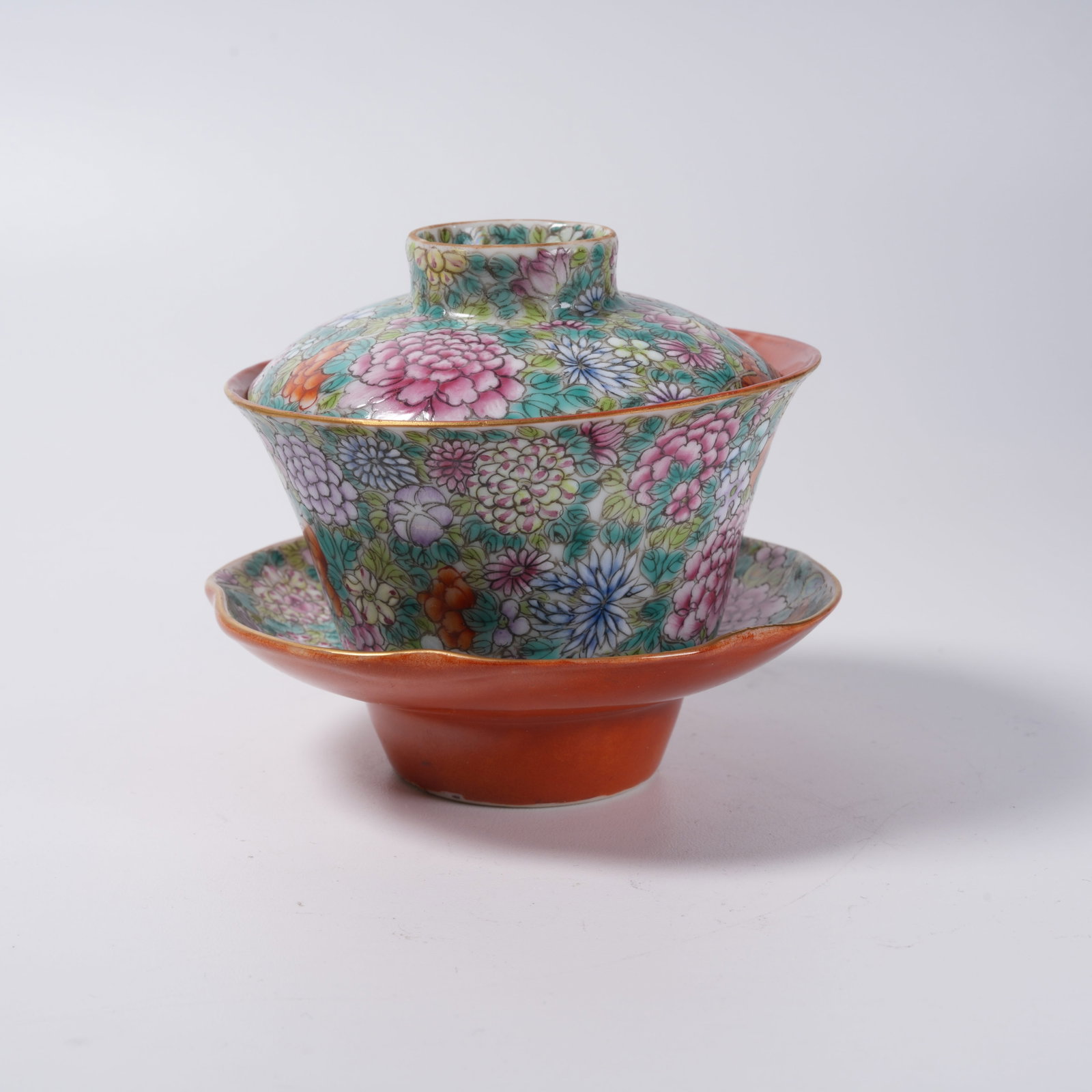 A SET OF FAMILLE ROSE COVERED CUPS AND SAUCERS WITH ALL-OVER FLORAL PATTERN: Set of Famille Rose Covered Cups and Saucers with All-over Floral Pattern