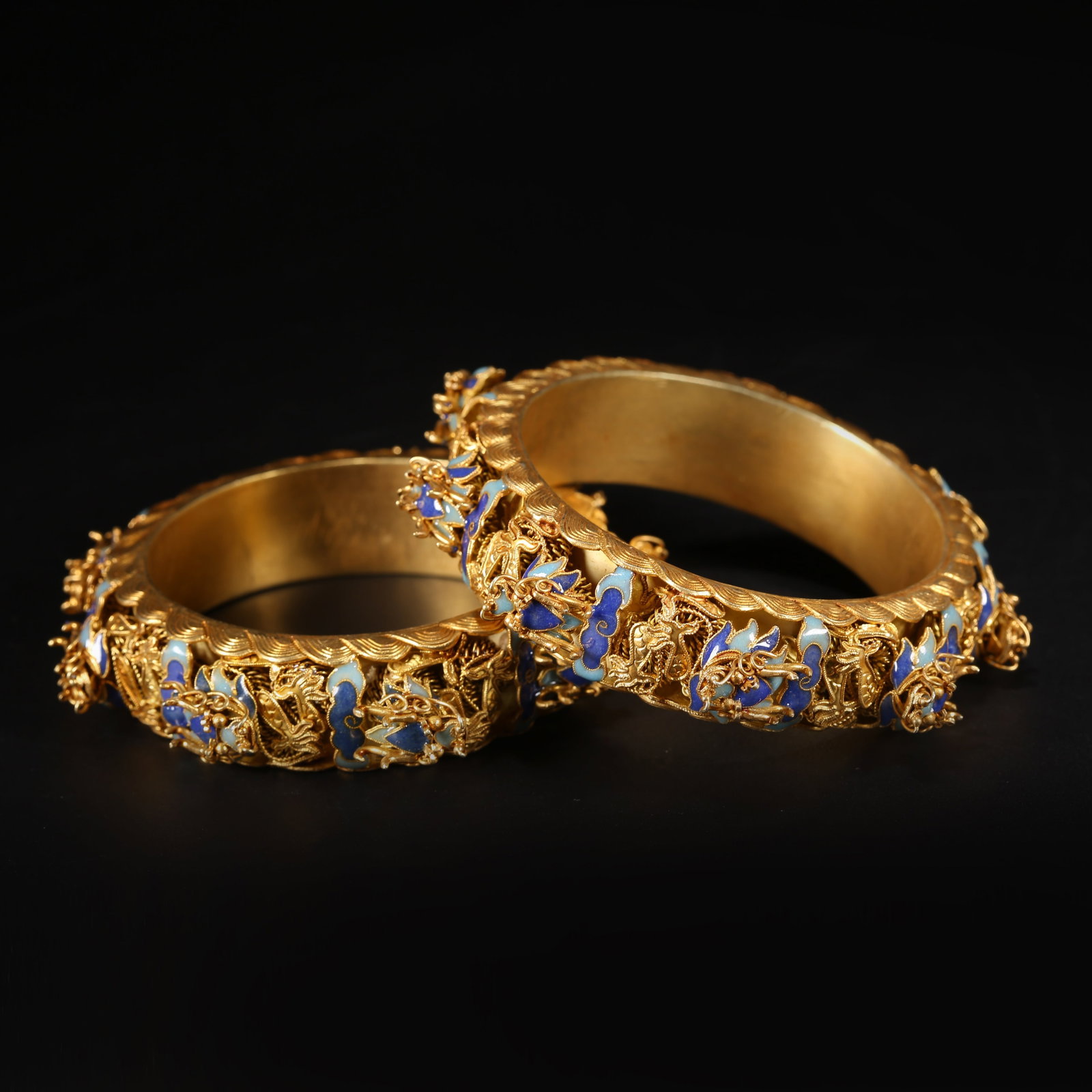 A SET OF SILVER GILT, FIRE-BLUE DRAGON MOTIF BRACELETS: Set of Silver Gilt, Fire-Blue Dragon Motif Bracelets
