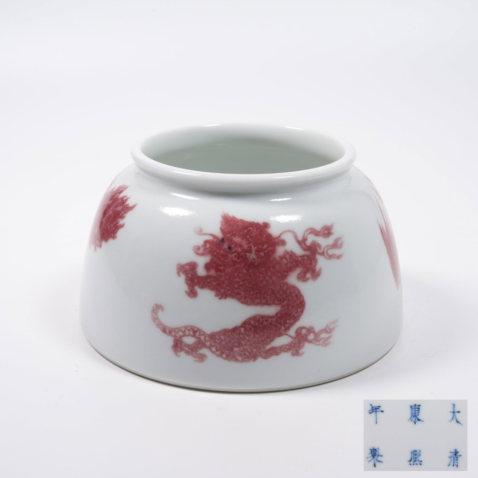 A UNDERGLAZE RED HORSESHOE ZUN WITH DRAGON AND PHOENIX PATTERN: Underglaze Red Horseshoe Zun with Dragon and Phoenix Pattern