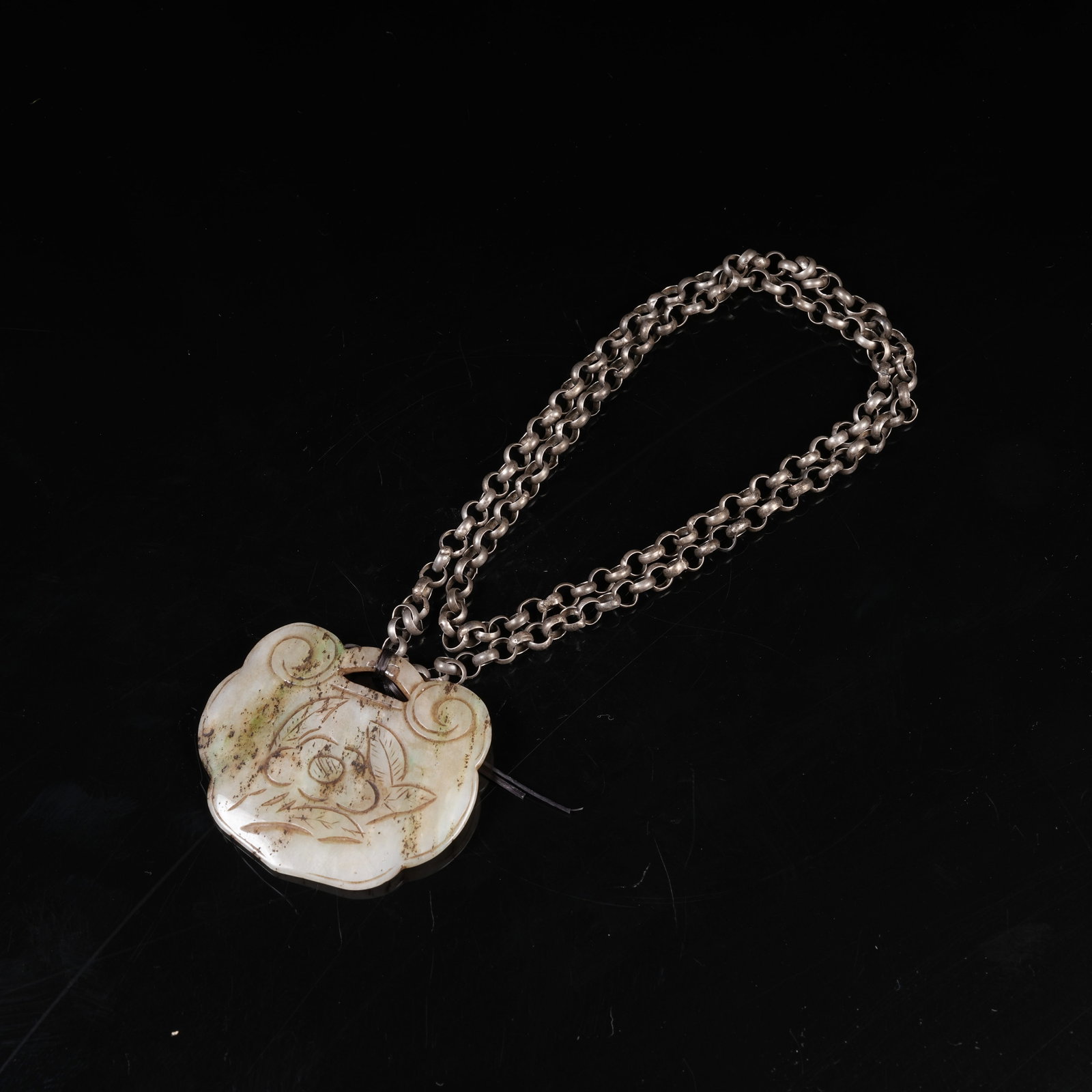 A NEPHRITE LONGEVITY LOCK WITH FLORAL PATTERN: Nephrite Longevity Lock with Floral Pattern