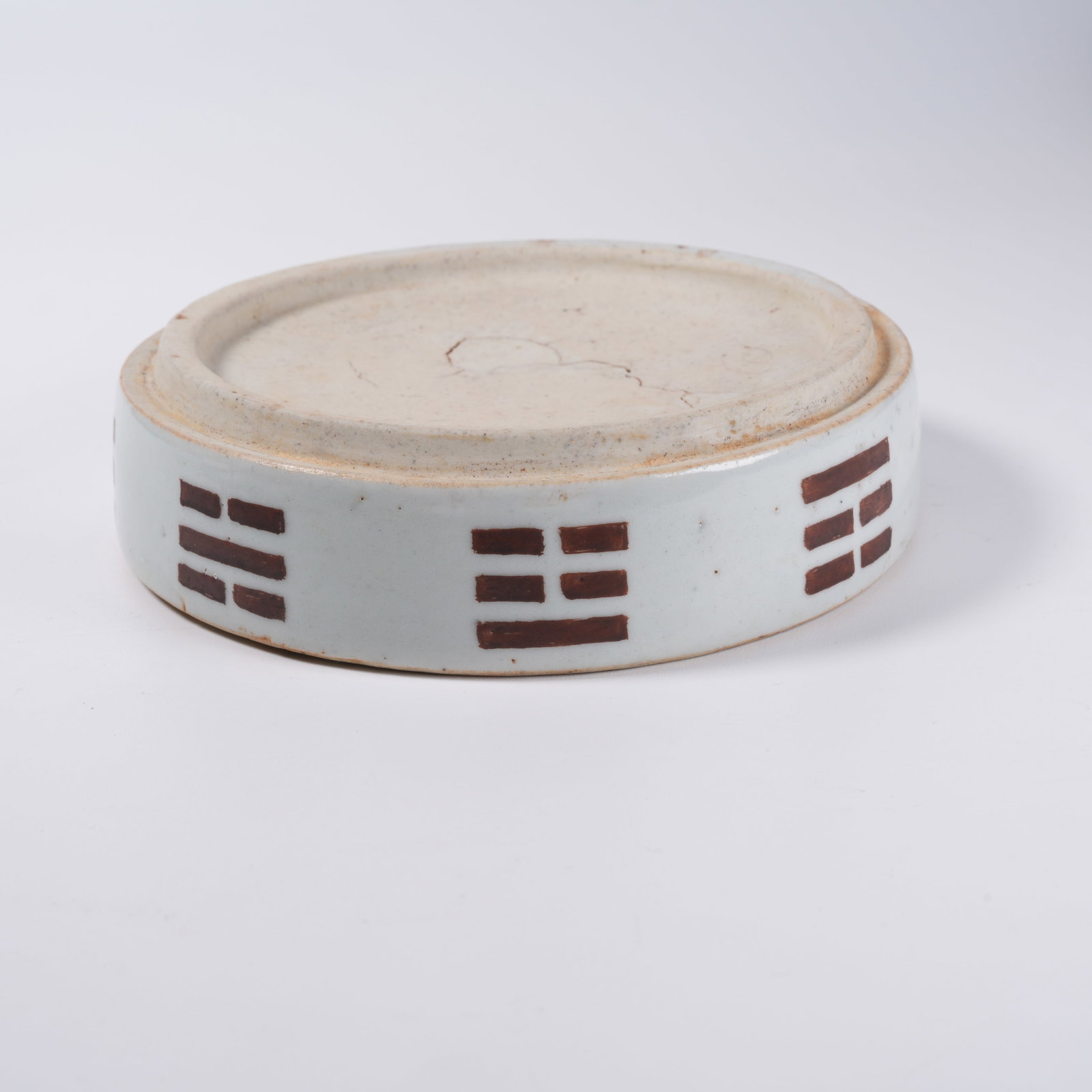 A WHITE GLAZED BROWN COLORED INK STONE WITH EIGHT TRIGRAMS PATTERN: White Glazed Brown Colored Ink Stone with Eight Trigrams Pattern