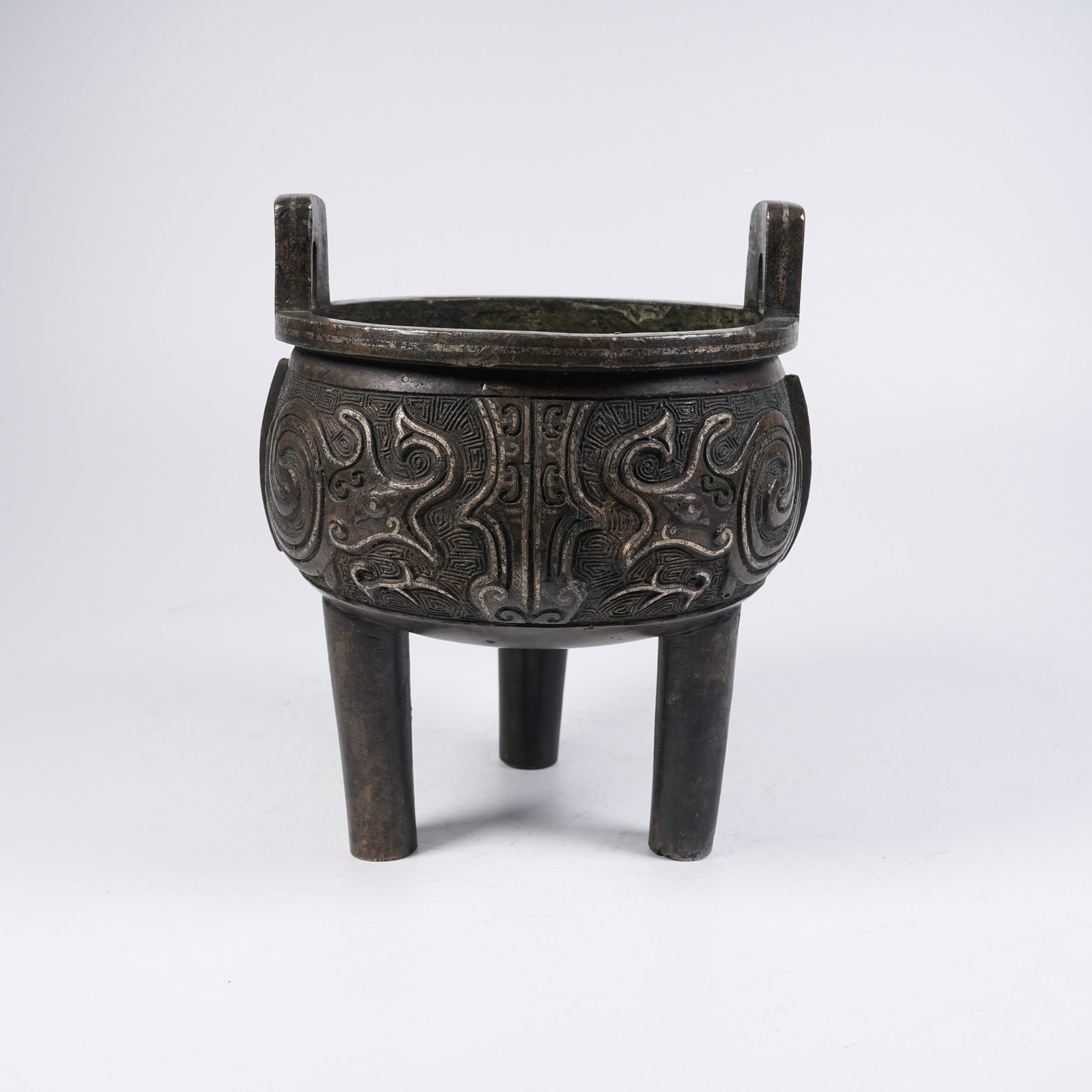 A BRONZE FLANGED DING-SHAPED CENSER WITH BEAST MASK PATTERNS: Bronze Flanged Ding-shaped Censer with Beast Mask Patterns