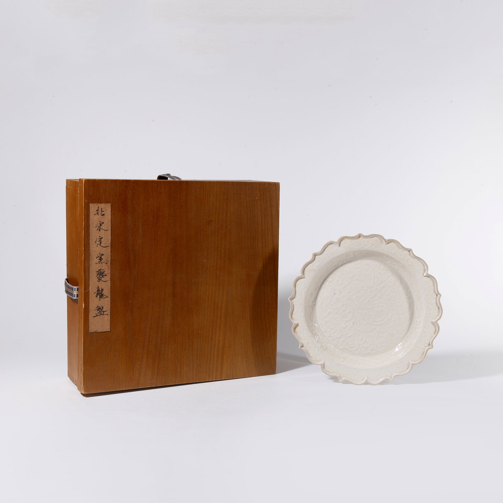 A DING KILN PLATE WITH DRAGON AMID FLORAL SPRAYS PATTERN: Ding Kiln Plate with Dragon amid Floral Sprays Pattern
