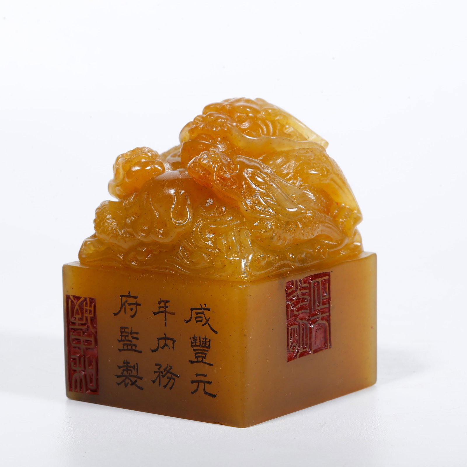 A SEAL WITH THREE-DRAGON KNOB CARVED FROM SHOUSHAN STONE: Seal with three-dragon knob carved from Shoushan stone