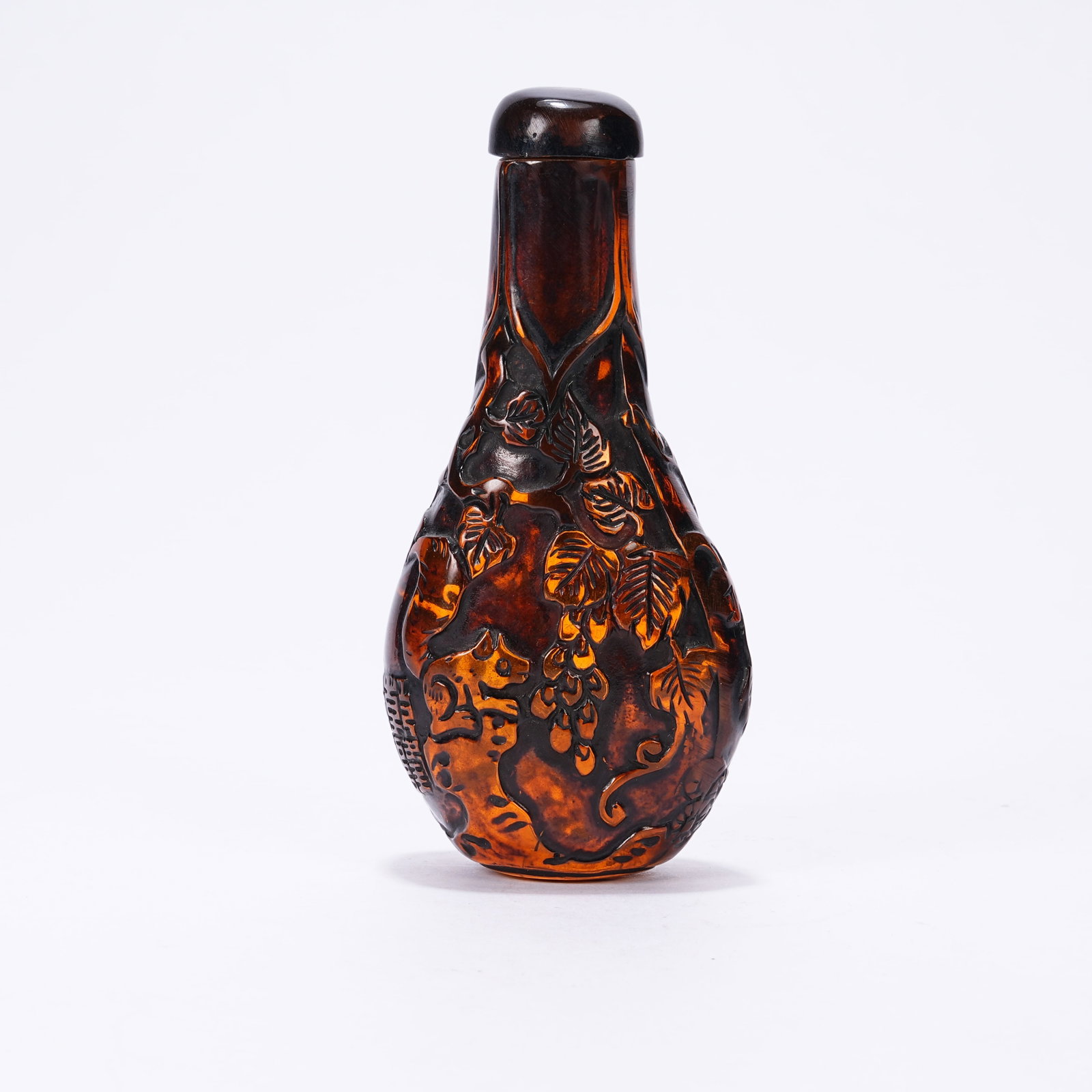 A AMBER SNUFF BOTTLE WITH SQUIRREL AND GRAPE PATTERN: Amber Snuff Bottle with Squirrel and Grape Pattern