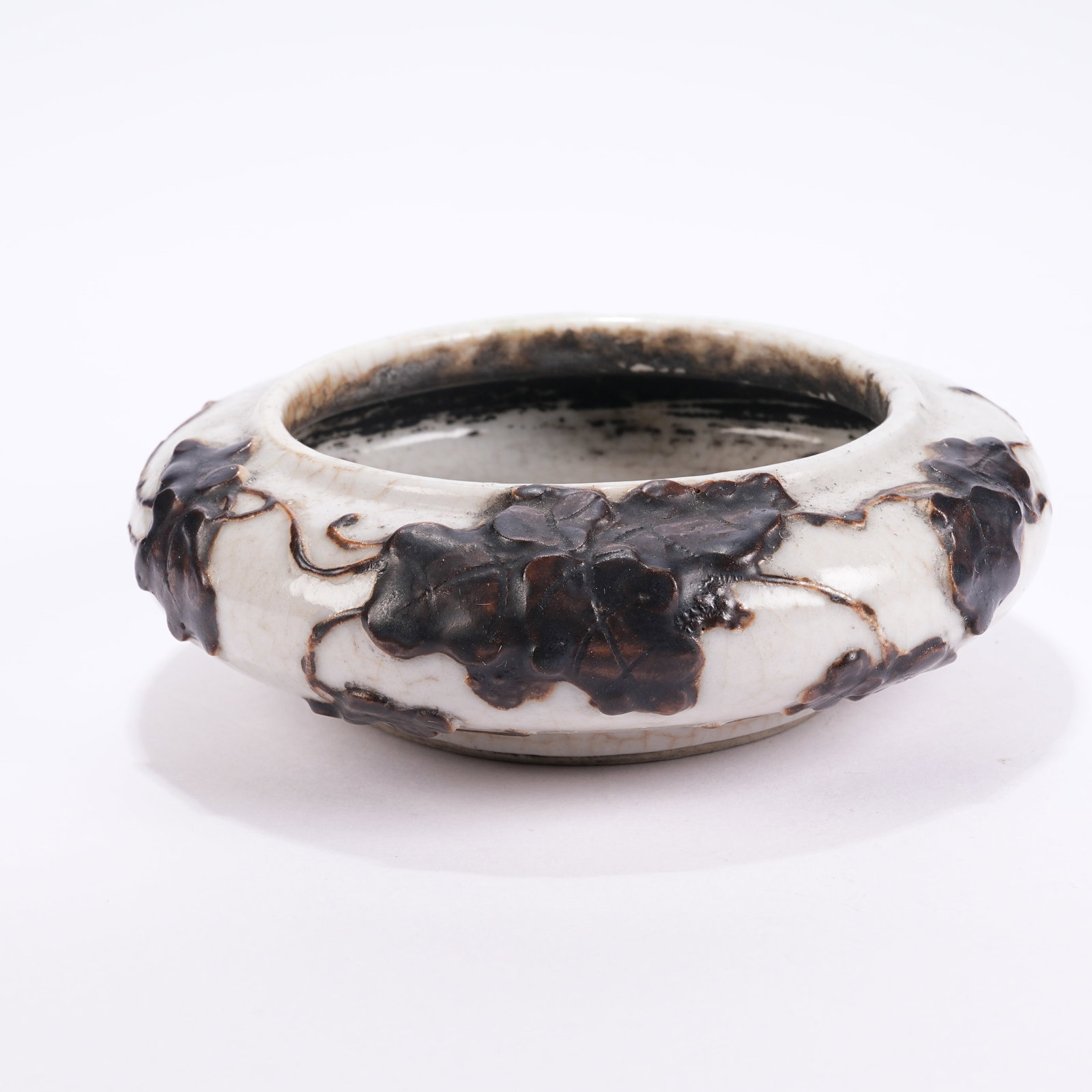 A WHITE GLAZE EMBOSSED LOTUS LEAF WASHER: White Glaze Embossed Lotus Leaf Washer