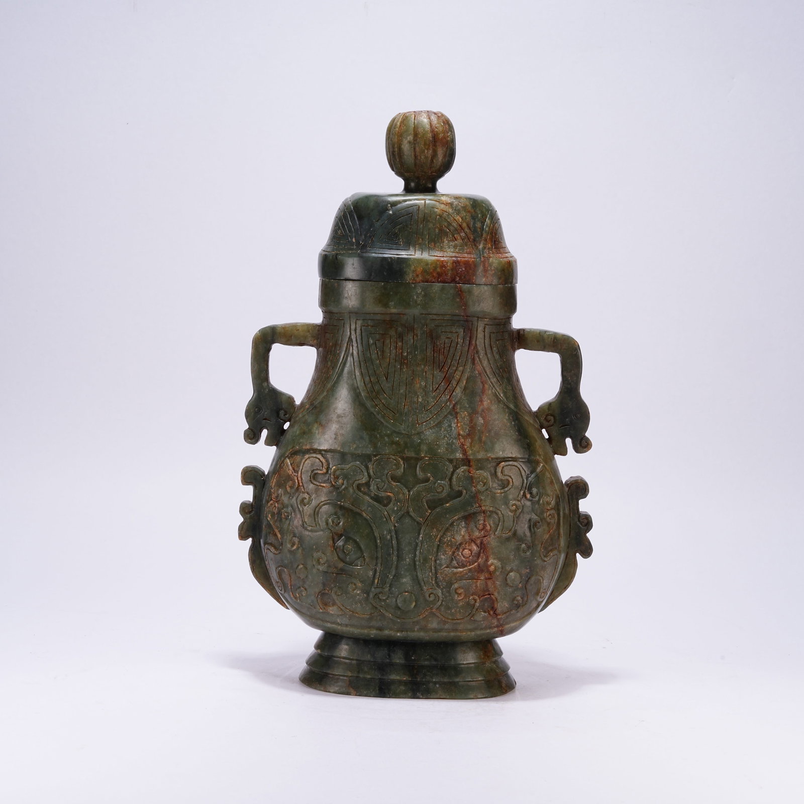 A HETIAN JASPER LIDDED VASE WITH DRAGON EARS AND BEAST MASK: Hetian Jasper Lidded Vase with Dragon Ears and Beast Mask